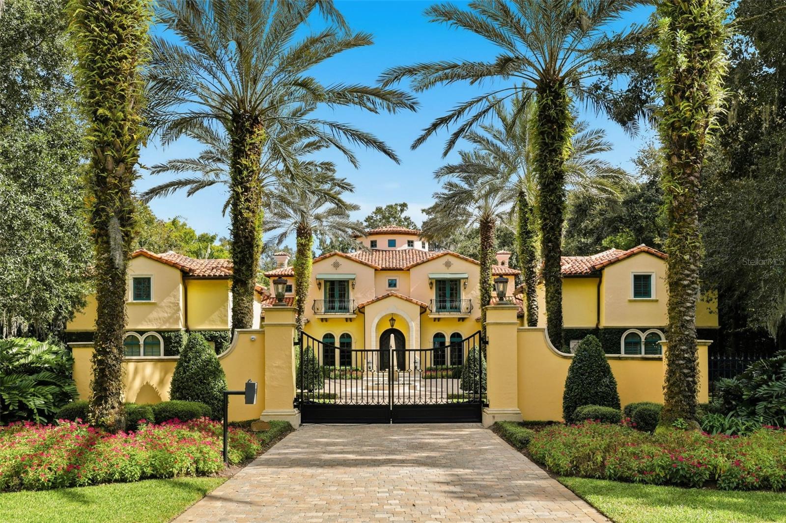 In the exclusive community of Windsong on Lake Berry, this magnificent 1.6-acre gated Mediterranean estate is a private oasis. With over 11,000 square feet of living area and a beautifully landscaped lakefront lot, this residence offers an exceptional blend of elegance, charm and privacy rarely found in Winter Park. The home features seven spacious bedrooms and nine full and two half baths. Entertain in the all-glass conservatory, dedicated theater room with motorized seating and a fully equipped game room. Modern conveniences throughout including gas-powered generators, an elevator and dumbwaiter. Two above-garage apartments provide ideal accommodations for guests and family. Outdoors, enjoy an expansive covered lanai, infinity edge pool and spa, boat dock with jet ski lift, and a summer kitchen complete with wood-burning fireplace, gas grill, refrigerator and icemaker, all overlooking the beautifully landscaped yard and lake. With its private gated entrance, this home is a one-of-a-kind opportunity to enjoy all the amenities Winter Park and Windsong have to offer.