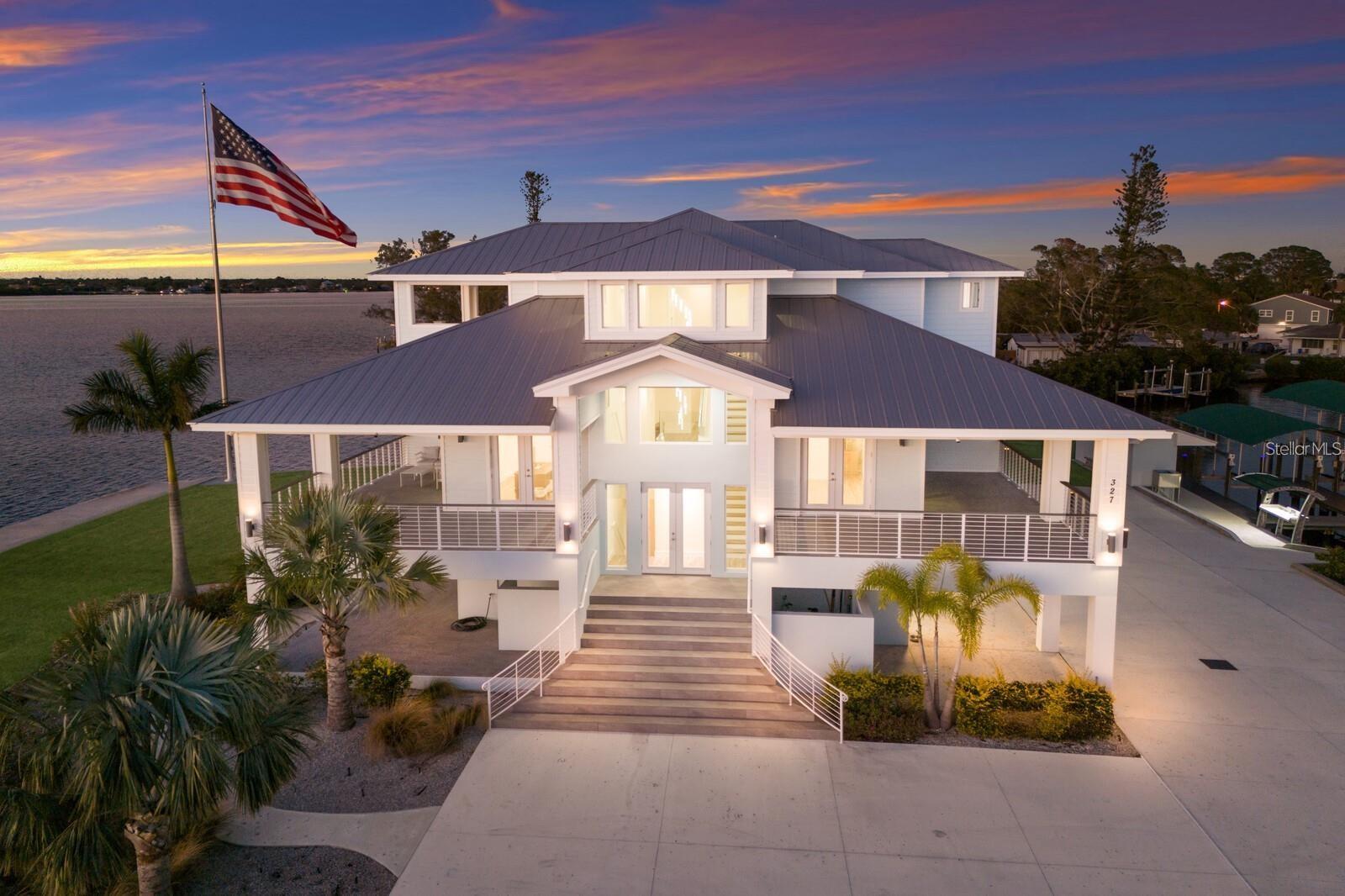 PARADISE POINT...A WATERFRONT MASTERPIECE ON THE MANATEE RIVER!!! Nestled on a PRIVATE 2.20 ACRE PENINSULA, Paradise Point is a breathtaking waterfront GATED ESTATE offering unmatched LUXURY and DIRECT ACCESS to the Manatee River, Tampa Bay and the Gulf. This 2023 custom built Key West style home boasts over 670 feet of water frontage, providing panoramic views of the Manatee River. YOU WILL NOT FIND A BETTER VALUE FOR A NEW WATERFRONT HOME ON ACREAGE!!! Imagine absolutely stunning sunrises followed by even more beautiful sunsets in the evening, all while sitting on your multiple covered lanais on each level of the house! Truly a Home of Luxury & Comfort. Spanning nearly 6,000 square feet of air-conditioned space, with a total of over 12,800 square feet including porches and garage space, this home is designed for both relaxation and grand entertaining. The open-concept living area showcases expansive water views out of almost every room. As soon as you enter the main living area you will notice the high ceilings and natural light streaming in thru all the windows in the great room. The gourmet kitchen is a chef’s dream, featuring Wolf and Thermador appliances, gorgeous shaker style cabinetry, dual dishwashers, and a huge island that is the perfect spot for hosting gatherings. Take the stairs or elevator to the private third-floor owner’s suite. Truly a serene retreat, complete with a spacious lanai with cypress ceilings, two oversized walk-in closets, and a spa like bathroom featuring a Jacuzzi soaking tub and a 12’x8’ Thermosol wet sauna steam shower. The main level offers four additional bedrooms, including one ideal for a home office. A 15-person theater room on the first floor elevates the home’s entertainment experience. The 6 car garage is huge and offers endless possibilities for the car enthusiasts or just for those looking for storage. Built for absolute strength, this home was constructed way beyond standard building codes! This estate is engineered for maximum durability and energy efficiency. With a completely solid block structure, reinforced concrete floors, a fire sprinkler system, and state-of-the-art roofing material with polyurethane insulation, it provides superior storm resistance. Its high elevation has ensured it remains completely dry through past hurricanes, offering unparalleled security and peace of mind! The exterior is truly an outdoor paradise for boating & entertaining! Designed for those who love the water, this estate features plenty of dock space along a protected deepwater lagoon. You can tell that this area was designed by someone with lots of experience on the water and that they constructed this area with an open check book! Featuring trex decking, built in dock lighting and two private covered boat slips—one with a 16,000 lb lift and the other with a 10,000 lb lift—as well as a concrete shed to store all your boating/fishing gear and your ice machine! Additionally, there is a fish cleaning station and shore power at the dock. Truly a dream set up!! Conveniently located just minutes from downtown Bradenton, this estate is near top-tier schools, including IMG ACADEMY, ST STEPHENS AND BRADENTON CHRISTIAN SCHOOL! Only minutes to the Gulf Beaches of Anna Maria Island, short distance to downtown St. Pete and the cultural & culinary arts of Sarasota. TRULY AN AMAZING LOCATION WITH EASY ACCESS TO SO MANY OPTIONS!