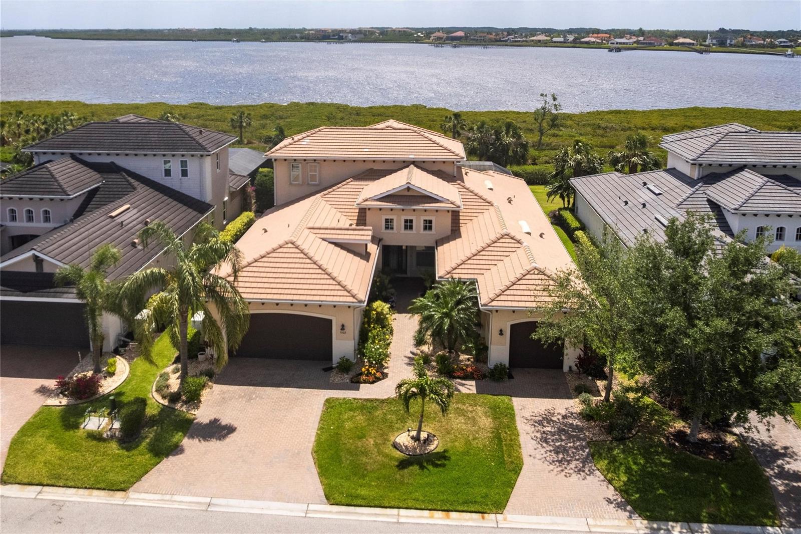 Welcome to elevated waterfront living in Tidewater Preserve, one of Bradenton's most sought-after gated boating communities with no CDD fees. Perfectly positioned with sweeping views of protected preserves and tranquil waterways, this exceptional two-story waterfront pool home blends elegant coastal design with modern luxury. Meticulously maintained and thoughtfully upgraded, the home has recent investments, including the replacement of one of the home's Trane air-conditioning systems (2026), a newer pool pump (2025), and a newer pool heater (2024), providing added comfort and peace of mind. Spanning 3,460 square feet, this thoughtfully designed residence offers three bedrooms, a private den, a spacious bonus room, 4.5 bathrooms, and a three-car garage—creating an ideal balance of luxury, functionality, and privacy. Designed to embrace its stunning waterfront setting, the open-concept floor plan is filled with natural light through expansive windows that frame picturesque preserve and water views throughout the home. The gourmet kitchen serves as the heart of the residence, featuring quartz countertops, stainless steel appliances, an induction cooktop, custom pantry storage, pull-out cabinetry, and an oversized island perfect for casual dining and entertaining. The owner's suite is a peaceful waterfront retreat, offering tranquil views, a spa-inspired bath, and dual custom walk-in closets. Each guest bedroom features its own ensuite bath, ensuring comfort and privacy for family and guests alike. Upstairs, a versatile bonus room with a full bath provides endless possibilities as a media room, game room, fitness studio, or private guest retreat. Step outside onto the second-story lanai and enjoy sweeping views of the surrounding preserves and waterways. Exceptional outdoor living awaits with two expansive lanai spaces overlooking the water and preserve. A heated saltwater pool and fully equipped outdoor kitchen create the perfect setting for entertaining, relaxing, and enjoying Florida's year-round indoor-outdoor lifestyle. Additional features include a whole-house generator, storm protection, automated lanai screens, custom lighting, plantation shutters, crown molding, central vacuum, indoor and outdoor speakers, a water filtration system, custom closet systems, and a security system. Residents of Tidewater Preserve enjoy access to a private marina with direct Manatee River access, two clubhouses, a fitness center, Har-Tru tennis courts, kayak launches, scenic nature trails, and resort-style amenities. Ideally located just minutes from downtown Bradenton, Lakewood Ranch, Sarasota, and the world-renowned beaches of Anna Maria Island, this exceptional waterfront home delivers the very best of Florida living.