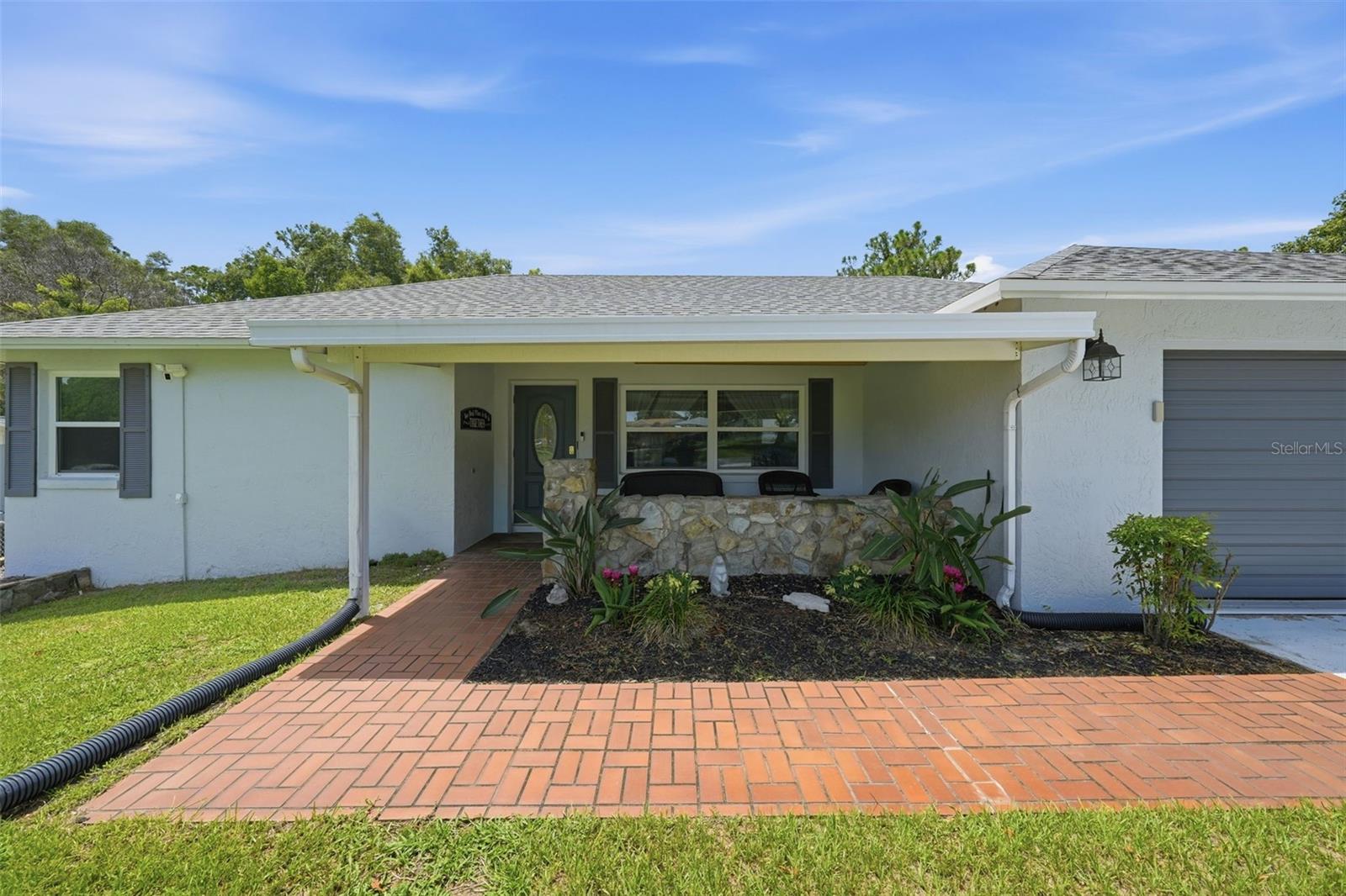 Welcome to 42 S J Kellner Boulevard in Beverly Hills, Florida! Enjoy comfortable Florida living in this well-maintained 2-bedroom, 2-bath ranch-style home located in the desirable Beverly Hills community with no HOA. This home offers approximately 1,268 square feet of living space with a spacious layout, updates throughout, and a fenced back yard. Step inside to find a bright and inviting interior featuring luxury vinyl flooring in the main living areas, laminate flooring in the Florida room, and tile flooring in the kitchen. The home offers a warm and welcoming atmosphere with a wood-burning fireplace, vaulted ceilings, and a kitchen skylight bringing in natural light. The kitchen includes a breakfast bar, laminate countertops, and appliances including refrigerator, range, dishwasher, and microwave hood. The home has been thoughtfully updated with major improvements including a new HVAC system in 2024, roof in 2022, water heater in 2020, interior paint in 2022, and exterior paint in 2024. The renovated bathroom adds a fresh modern touch. newer tinted windows, Sensi smart thermostat, and updated appliances approximately 4 years old. Enjoy the added living space with a Florida room featuring HVAC, great for relaxing, entertaining, or additional flex space. Step outside to the patio area overlooking the fenced chain-link yard with a sprinkler system and a 10x16 storage shed (built in 2015). The front porch with decorative rock wall adds to the home's curb appeal. The attached 2-car garage provides convenience with garage door opener, laundry area, and washer and dryer conveying with the property. Additional features include an video doorbell camera for added security. Located near Beverly Hills community amenities including parks, community center, and pickleball courts, and convenient to shopping, dining, medical facilities, golf, and all the outdoor recreation Citrus County has to offer. Furniture is available for purchase separately. Home is being sold AS IS. Schedule your showing today.