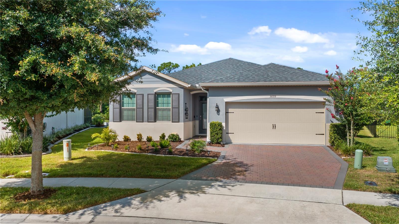 Welcome to carefree luxury living in one of the area's most desirable gated 55+ communities, where beautifully maintained grounds, resort-inspired amenities, and a vibrant social atmosphere create the lifestyle you have been waiting for. Perfectly positioned on a premium homesite with no rear neighbors, this exceptional four bedroom residence overlooks HOA owned conservation land and a tranquil pond, offering peaceful views filled with graceful water birds and the calming beauty of nature. Whether you are enjoying your morning coffee or an evening beverage from the expansive screened lanai, the private backyard setting is a daily reminder of why this location is so special. Designed for both comfort and style, this thoughtfully crafted home features four true bedrooms, providing the flexibility to accommodate guests, hobbies, a home office, or multigenerational living without compromise. The open concept floor plan creates an inviting flow between the kitchen, dining and living space, making it equally suited for quiet evenings at home or entertaining family and friends. The kitchen is the heart of the home, showcasing abundant white cabinetry, stainless steel appliances, a spacious center island with seating, granite countertops, and generous workspace for preparing meals while remaining connected to the surrounding living areas. Natural light pours through the windows, highlighting the clean lines, neutral finishes, and welcoming atmosphere throughout. Luxury vinyl plank and porcelain tile flooring extend throughout the home, offering both timeless appeal and easy maintenance with no carpet to worry about. The spacious primary suite provides a relaxing retreat, while the additional bedrooms are generously sized and thoughtfully separated to provide privacy for family and guests. Practical upgrades enhance everyday living at every turn. The oversized garage has been finished with an attractive epoxy painted floor and includes hanging overhead storage racks to maximize organization. An electric vehicle charging station is already installed for modern convenience, while a whole house water filtration system adds another level of comfort and peace of mind. One of the home's most captivating features is the outdoor living space. The screened rear lanai serves as a true extension of the home, inviting you to relax while enjoying uninterrupted views across the conservation area. With no homes directly behind you, the setting offers an uncommon sense of privacy and serenity rarely found in community living. Life here extends well beyond your front door. Residents enjoy an impressive collection of resort style amenities including a beautiful clubhouse, sparkling pool, modern fitness center, clubs, and activities designed to help neighbors connect and enjoy an active lifestyle. The welcoming atmosphere and friendly community spirit make it easy to feel at home from the moment you arrive. Conveniently located with easy access to US Highway 27, you are just minutes from shopping, restaurants, medical facilities, and everyday conveniences while remaining close to Orlando's world class attractions, championship golf courses, lakes, parks, and endless recreational opportunities. If you have been searching for a home that combines modern upgrades, a peaceful water view, exceptional privacy, and the unmatched lifestyle of an active adult gated community, this remarkable property offers the perfect opportunity to enjoy the very best of Florida living.