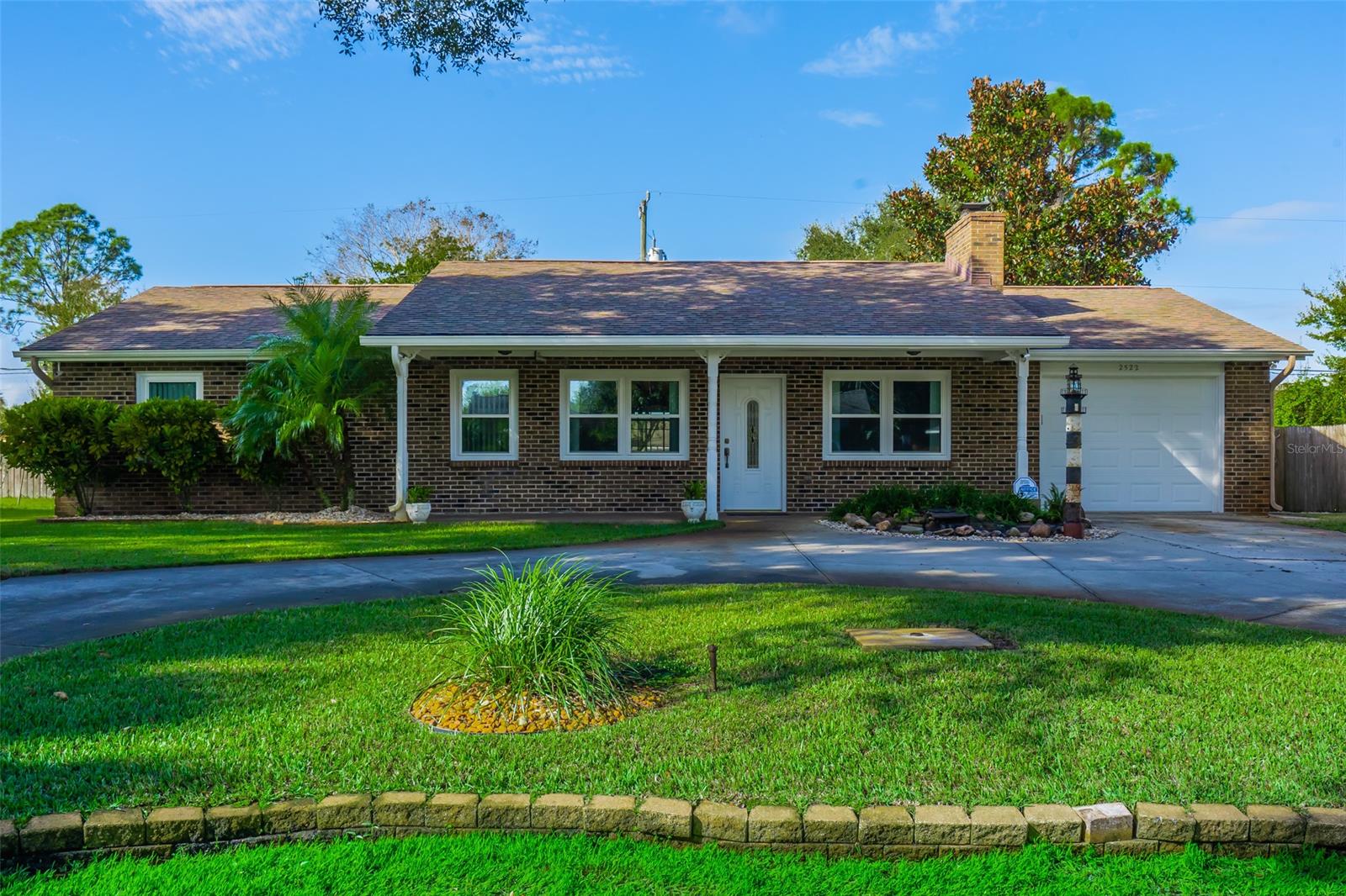 Beautiful brick front home in the Florida Shores! Stunning curb appeal and circular driveway with coy pond is what you will find upon your arrival at this 1,410 sq. ft. one car garage home. This 3BR/2BA home has a kitchen with breakfast bar and a large living/dining area with a wood burning fireplace. Bedrooms with ceiling fans. New windows installed in 2020, and exterior paint 2018. Relax on your shaded front porch or your large screened lanai with jacuzzi! Cool off in your private pool while overlooking the beautifully landscaped, fenced backyard! A great backyard for entertaining family and friends! Irrigation system runs off the well. This home has so much to offer and many possibilities! Only 8 miles to New Smyrna Beach and shops, and only 4 miles to I95. ;Water: City