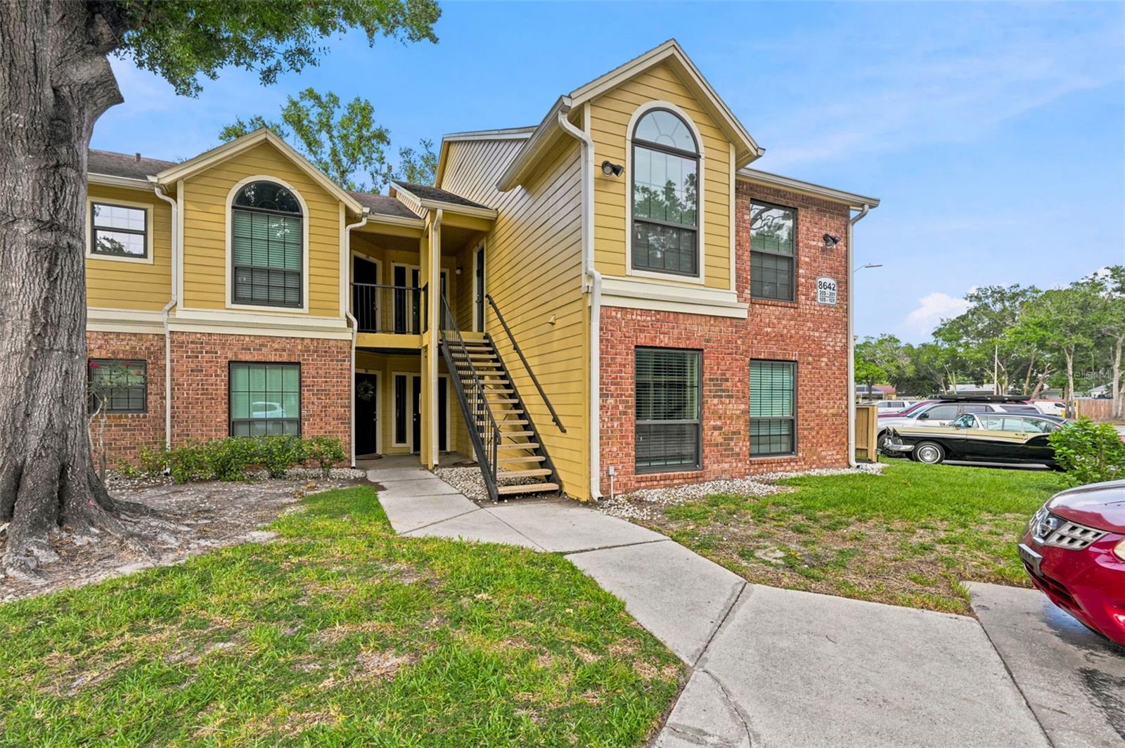 Welcome to this beautifully maintained first-floor end-unit condo in the gated community of Grand Reserve Condominiums of Tampa, offering the perfect combination of comfort and low-maintenance living. Inside, you'll find wood-look tile flooring throughout and an open-concept layout designed for everyday living. The kitchen features stainless steel appliances, granite countertops, oak cabinetry, a pantry closet, breakfast bar, and an adjacent dining area. The nicely sized bedroom offers a ceiling fan, a walk-in closet, and access to the shared bathroom. The bathroom is well-appointed with a granite-top vanity and a beautifully tiled shower. Step outside to your private side patio, complete with a privacy fence, creating the perfect space to enjoy your morning coffee or unwind at the end of the day. Residents of Grand Reserve enjoy an array of resort-style amenities, including a community pool, spa, and tennis courts. Conveniently located near shopping centers, countless dining options, and major roadways, this home is approximately 20 minutes from Tampa International Airport, Busch Gardens, and Downtown Tampa, making it an ideal primary residence, seasonal retreat, or investment opportunity. Schedule your showing today!