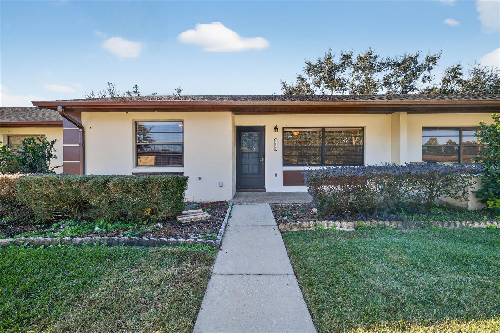 Welcome to easy Florida living in the desirable 55+ Summit Chase Villas community! This beautifully maintained 2-bedroom, 2-bath villa offers an inviting open floor plan with tasteful updates throughout and is ready for its next owner.
Step inside to discover luxury vinyl plank flooring, fresh neutral paint, and a spacious living and dining area that provides plenty of room for entertaining or simply relaxing. The updated kitchen features attractive countertops, stainless steel appliances, a deep sink and abundant cabinet space. 
The generously sized primary suite includes a large walk-in closet and an updated ensuite bathroom with a walk-in shower. The guest bedroom is perfect for visitors or a home office and is conveniently located near the remodeled guest bathroom.
Enjoy your morning coffee or unwind in the enclosed Florida room overlooking the peaceful green space behind the home. Additional features include an interior laundry room, covered front porch, covered carport, and exterior storage.
Summit Chase Villas offers a low-maintenance lifestyle with community amenities including a clubhouse, swimming pool, shuffleboard courts, and beautifully maintained grounds. Conveniently located just minutes from shopping, restaurants, medical facilities, downtown Tavares, Mount Dora, and the Harris Chain of Lakes, this home offers the perfect combination of comfort, convenience, and carefree Florida living.
Don't miss your opportunity to own this move-in ready villa in one of Tavares' most desirable active adult communities!