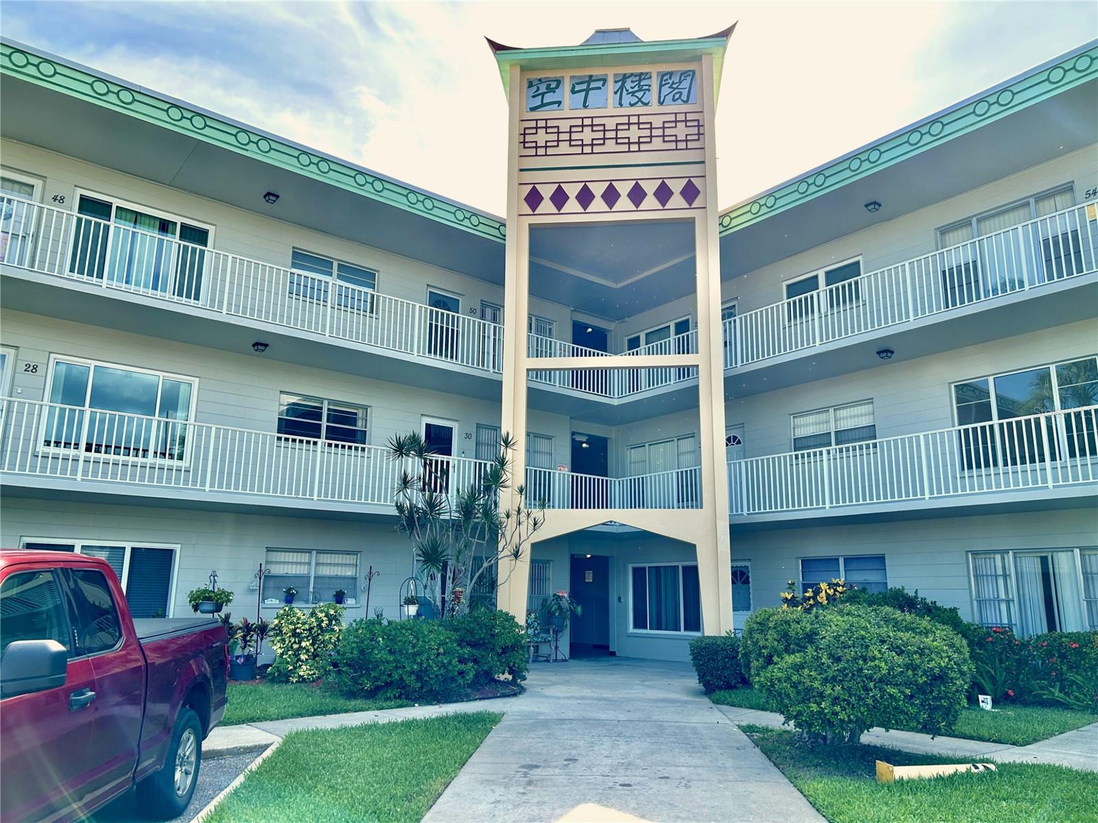Welcome to this meticulously maintained 2-bedroom, 2-bath condo, perfectly located directly across from the East Activity Center, where you'll enjoy convenient access to a heated pool, fitness center, tennis and pickleball courts, and more. Bright and inviting, the updated kitchen features shaker-style cabinetry, ceramic tile backsplash, stainless steel appliances, recessed lighting, and ceramic tile flooring perfect for everyday living and entertaining. Recent updates include a new A/C (2023), washer and dryer (2018), updated windows, and new carpeting throughout the living room, Florida Room, and both bedrooms. The spacious primary suite offers a beautifully renovated en suite bath with new wall and floor tile, updated shower doors, a large vanity and mirror, and a comfort-height commode. Enjoy resort-style living in this vibrant 55+ community featuring two private golf courses (9- and 18-hole), two heated pools, two activity centers, a remodeled fitness center, tennis, pickleball, hobby studios, a woodshop, billiards, fitness classes, dancing, clubs, and endless social activities. Pet lovers will appreciate the fenced dog park with covered seating, while the on-site Good Karma Café offers convenient snacks and beverages. Ideally located just minutes from award-winning beaches, shopping, dining, entertainment, and public transportation, this home offers the perfect blend of comfort, convenience, and an active Florida lifestyle. Association approval is required. This property conveys by leasehold estate deed. If financing, a 35% down payment is required. Don't miss this opportunity to own a beautifully updated home in one of the area's most amenity-rich communities. Schedule your private showing today. All washer, dryer & hook ups must be approved by the association.