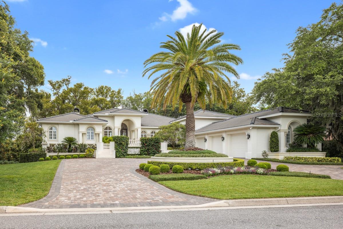 From the moment you enter this exquisite estate, you are embraced with an open and breathtaking view of Lake Isleworth.  Nestled between the lake and Isleworth Country Club’s driving range, the home boasts just over 6,500 sqft with 4 bedrooms, 4 full baths and a powder bath.  The newly renovated modern kitchen with state-of-the-art appliances welcomes you with an entertainment space, wine refrigerator and majestic lake views.  The elevator conveniently located by the kitchen and the garage, make it accessible to bring your groceries up.  The garage includes golf cart parking, a charging station and a lift for an additional car.  As you make your way downstairs to the open bonus room, 3 ensuites accommodate family and guests with access to the lakeside oasis with a spa and retractable screens around the large porch area.  A few steps away through the garden along a brick path is the enchanting beach shore and boat dock awaiting for you to enjoy the serene sunset views.