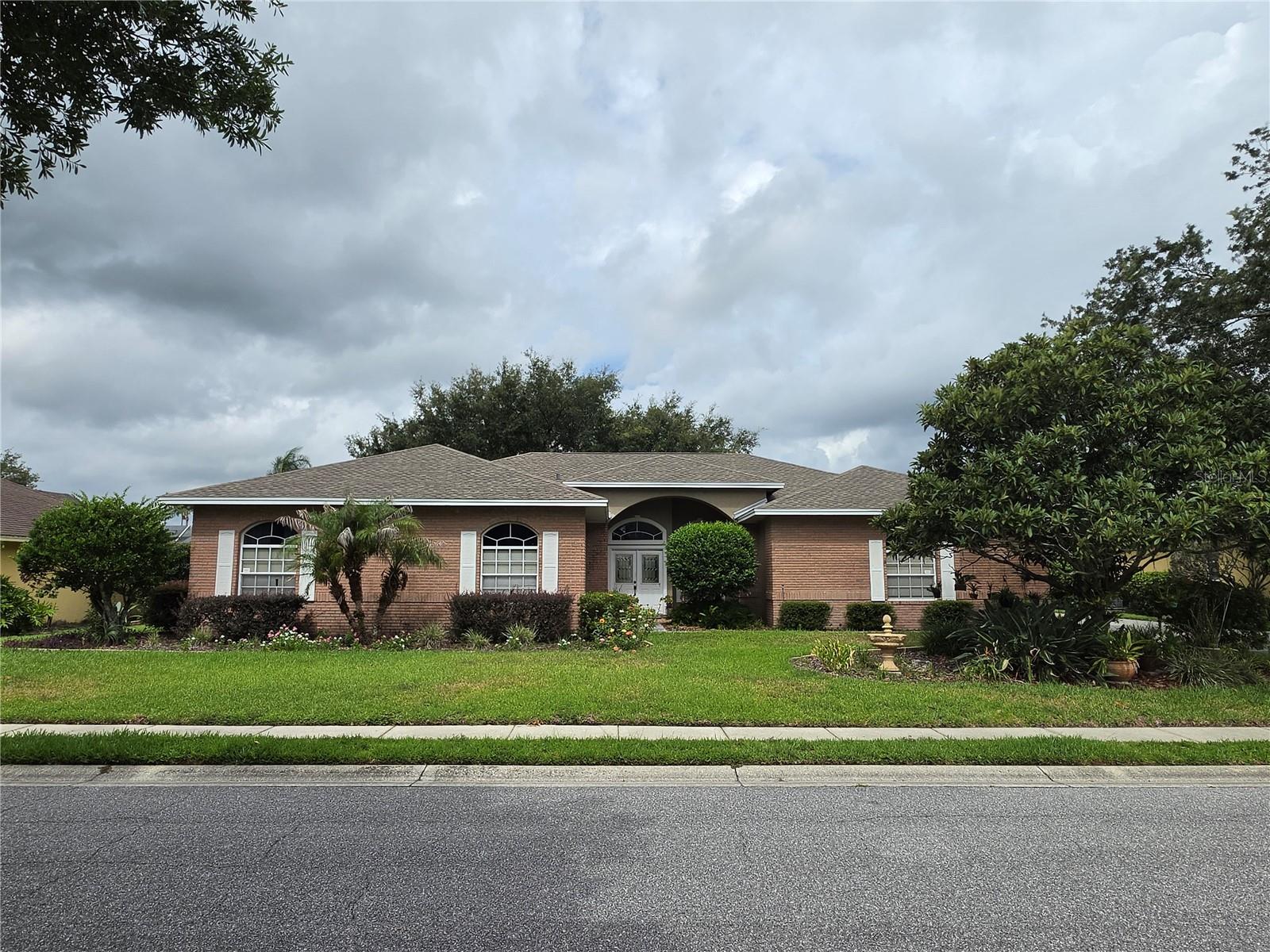 Gorgeous 4BR/3BA pool home located in the highly sought after area of South Lakeland. Close proximity to hospitals, shopping, Polk Parkway, I-4, Tampa and Orlando.  Located in the gated community of Crews Lake Hills, this home is nestled on a 1/3 of an acre amongst beautiful tree lined streets with mature landscaping including fruit bearing trees.  Some exterior features of this home include a large screen lanai with inground pool/spa, yard irrigation, roof installed January 2022, 3 car attached garage, dual HVAC systems that allow for separate heating/cooling areas.  Some interior features of this home include, beautiful wood cabinetry, large kitchen island to gather around with family and friends, granite countertops in the kitchen and bathrooms, dual living spaces, eat-in area in the kitchen as well as formal dining area, split bedroom, wood burning fireplace, steam shower in the guest/pool bath, indoor laundry room that includes utility sink.