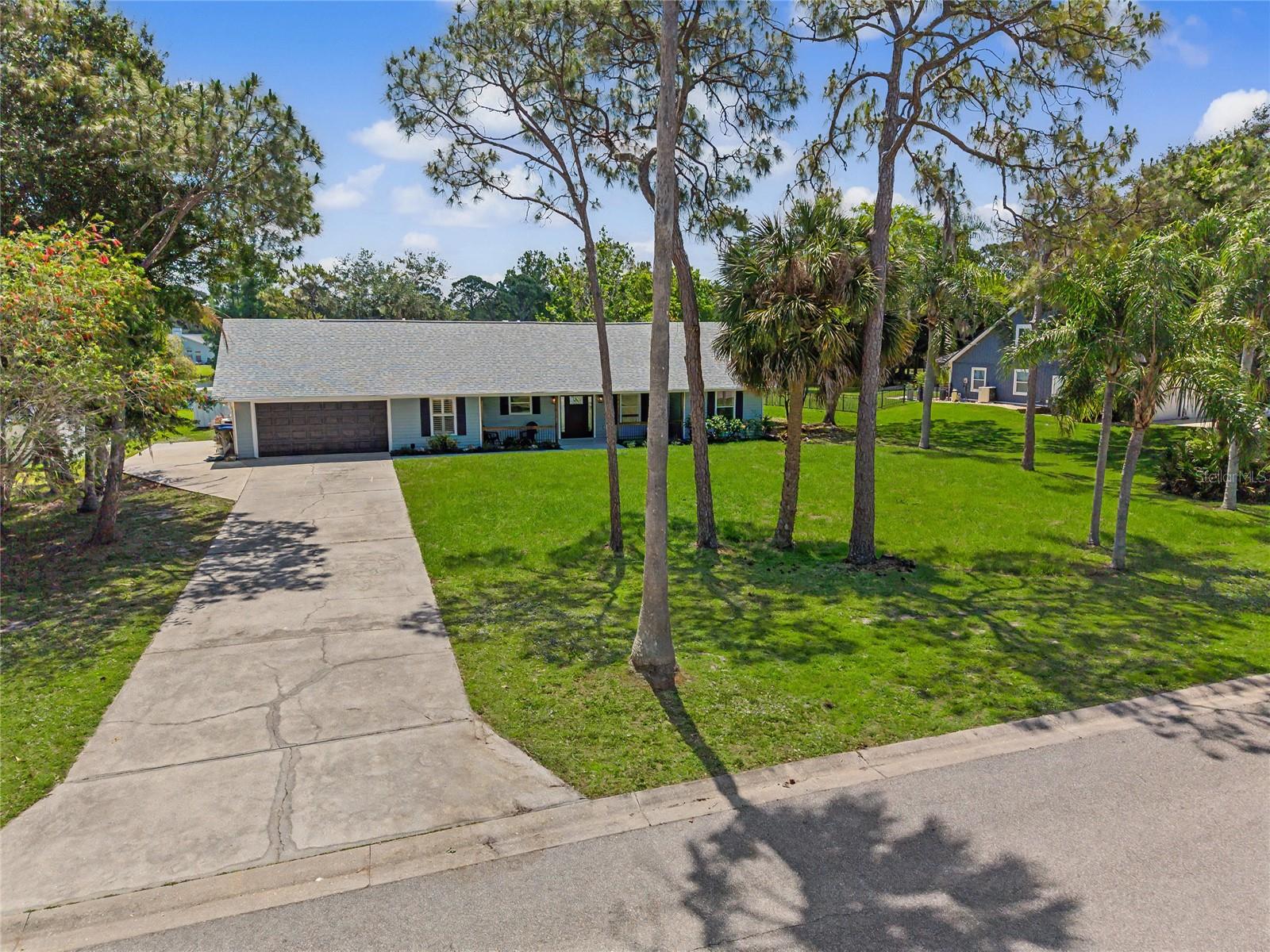A long private driveway provides ample off-street parking—ideal for entertaining family and guests—while the fresh landscaping creates outstanding curb appeal from the moment you arrive. Step inside this 3 bedroom, 2 bath home to discover a thoughtfully updated interior designed for modern comfort and style. Featuring a brand-new roof, new air-conditioning system, new flooring, fresh interior paint, updated electrical finishes, and a completely new septic system for peace of mind. The stunning new kitchen showcases sleek cabinetry, stainless steel appliances, and an inviting layout perfect for everyday living or entertaining. Both bathrooms have been tastefully renovated with contemporary finishes and fixtures. Additional features include an inside laundry room, attached 2-car garage, and a detached storage shed for added convenience. Outdoors, enjoy your own private oasis with a sparkling pool overlooking a tranquil lake, creating the perfect backdrop for relaxing evenings or weekend gatherings. A lakeside firepit adds warmth and charm, making this property ideal for enjoying Florida’s beautiful outdoor lifestyle year-round. This exceptional property offers the rare combination of modern upgrades, generous land, privacy, and scenic waterfront living—all within one of the area’s most desirable communities.