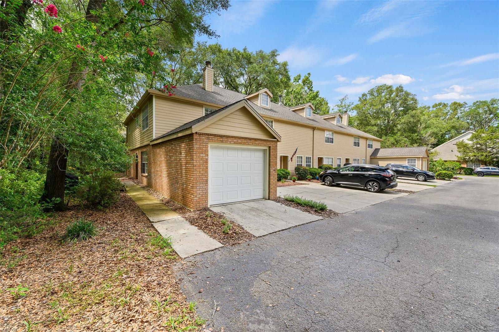 Beautifully updated end unit and very private 2 bedroom/ 2.5bath townhouse with one car garage in Haile Plantation Villas conveniently located nearby the Haile Village Center. Updated kitchen with solid oak cabinets, butcher block countertop, stainless steel appliances, subway tiles, barn door style pantry and reconditioned dresser for a new kitchen island, and porcelain tiles throughout the lower level. Just off the kitchen is a Florida room or office space. The kitchen peninsula creates an open floor plan. Living room features include hardwood crown moldings. The stairs going up to the second floor were redone with solid oak treads, risers and hand railing. The entire second level has been updated with laminate wood plank flooring and baseboards. Guest bath upstairs has been updated with new vanities, countertops, sinks and faucets. Large Owner suite has an owner bathroom and it has been updated with newer vanity and sink. Conveniently located just minutes to UF, Shands Hospital, VA hospital and Celebration Point. Enjoy a scenic quick access to walking trails. Don't miss this gem!