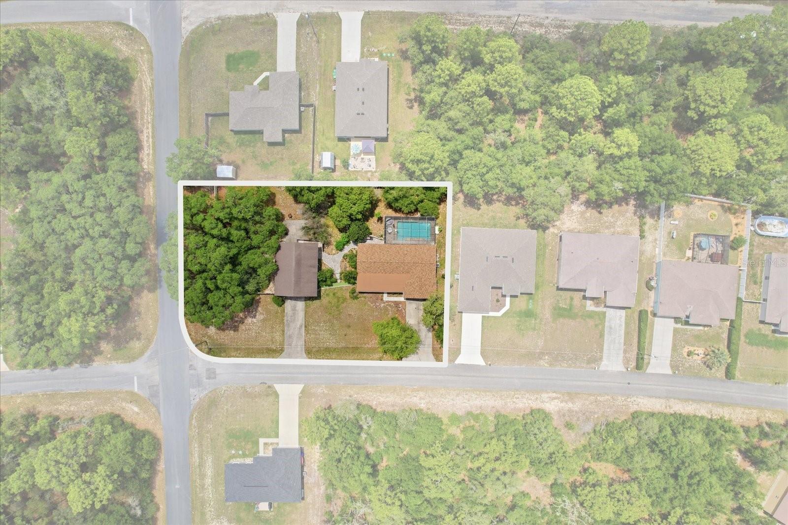 This beautifully updated 3-bedroom, 3-bath Citrus Springs POOL home offers the space, functionality, and backyard setting that are becoming harder to find. Situated on a fully fenced .57-acre corner lot with deed restrictions but no HOA, the wood-frame home features 1,832 sq ft of living space (2,212 total) along with a detached 30x40 concrete block garage that is truly in a league of its own. Inside the main home, recent improvements provide both style and peace of mind, including a NEW ROOF (May 2026), AC (2021), tankless electric water heater (2026), and updated electrical panel. The kitchen and primary bathroom have also been recently remodeled, blending modern finishes with comfortable everyday living. Designed with convenience and versatility in mind, the detached garage includes pull-through doors, 200-amp service, a dedicated office/workshop space, and a full bathroom - ideal for car enthusiasts, hobbyists, business owners, or additional storage needs. Above the garage, with its own private entrance, is an approximately 400 sq ft mother-in-law suite featuring an open floor plan, kitchenette, and mini-split system, creating an ideal setup for guests, multigenerational living, a private office, or flexible bonus space. Outdoors, the property transforms into a private backyard oasis with a screened 14x28 pool, paver patio, vinyl privacy fencing, and a beautiful mix of mature landscaping and fruit trees including lemon, citrus, loquat, and moringas. A rare opportunity to enjoy privacy, functionality, and room to spread out - all while remaining conveniently located near shopping, dining, medical facilities, and the Nature Coast’s outdoor recreation. Don't wait - call to schedule your showing today!