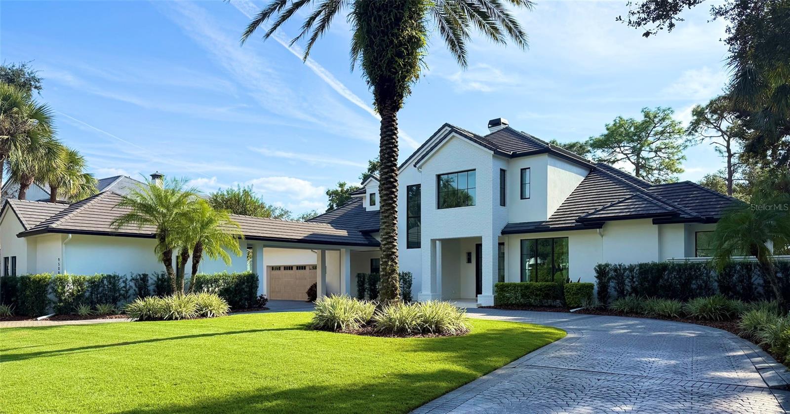 Welcome to this stunning transitional residence located behind the gates of the renowned Lake Nona Golf & Country Club. Set on 0.54 acres and spanning nearly 6,100 sq. ft., this beautifully reimagined home offers breathtaking golf and pond views from the moment you arrive.

Completely remodeled by DeVoe Custom Homes, every inch has been thoughtfully transformed, from the roof, windows, doors and everything on the interior. The heart of the home is the exceptional chef’s kitchen, featuring dual islands, custom cabinetry, top-of-the-line appliances, and unique stone countertops, complemented by an impressive oversized hidden pantry.

The first floor offers an ideal layout with the primary suite, a dedicated office, living room, dining room, kitchen, family room, a secondary guest suite, and a beautifully designed laundry room. The dining and living rooms share a striking double-sided gas fireplace, with the dining room highlighted by a stunning wood-clad ceiling.

Upstairs, a spacious loft with custom built-ins anchors three additional bedrooms, each with its own en-suite bath. A large screened balcony provides an elevated vantage point to enjoy serene views of the golf course and water.

Outdoors, the gorgeous pool sits against the perfect backdrop of championship fairways and tranquil pond scenery. The expansive covered patio features a tongue-and-groove ceiling and a well-appointed summer kitchen, ideal for effortless entertaining.

A four-car garage, circular driveway, and fresh professional landscaping complete the exceptional curb appeal.

This home truly has it all, luxury, design, functionality, and one of the most desirable settings in Lake Nona.