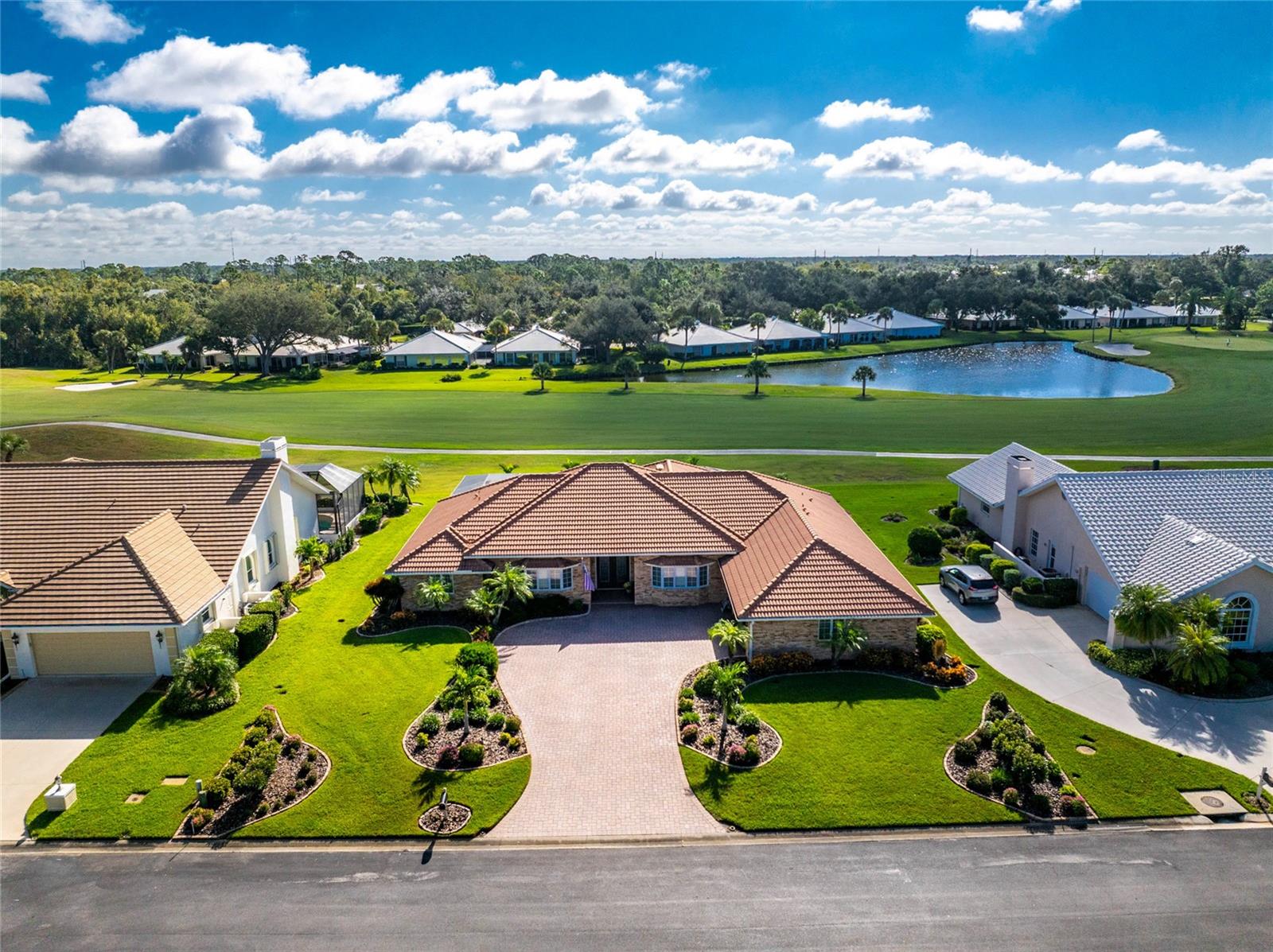 Paradise found on the 16th hole . . . a home designed for those who appreciate space, light, and the art of relaxed living. This bright, spacious, and thoughtfully designed 4-bedroom, 2.5-bath home is located in the gated Plantation Woods community at Plantation Golf & Country Club. With over 3,500 square feet under air, this home feels open, inviting, and filled with natural light, with a wall of sliding glass doors that frame panoramic views of the golf course and pond. The layout is a true split plan, offering maximum privacy and flow. The sprawling primary suite feels like its own private retreat! Close the pocket doors and you’ve got five rooms all to yourself: a large bedroom, renovated, spa-inspired bath, office, an oversized walk-in dressing room (even the closet has a closet!), and a flexible bonus room with direct pool access. The kitchen stretches across 25 feet of cabinetry and quartz countertops, blending beauty and function with high-end appliances, including a GE Monogram wine cooler and dual ovens. The open design connects seamlessly to dining and living areas, perfect for everyday living or hosting friends. Enjoy morning coffee and evening sunsets in the air-conditioned Florida room with motorized blinds, or relax by the Pebbletec pool surrounded by a new paver deck, cage, and heat pump. Every detail of this home, from lighting to fixtures, has been carefully updated. Optional Membership is available at Plantation Golf & Country Club that includes 2 Championship golf courses, 13 tennis courts, 6 pickleball courts, bocce, Jr Olympic Pool with tiki bar, and a full-service restaurant which features LIVE entertainment every week year-round!!! There are many member activities throughout the year. All this in a sought-after golf course setting close to both Wellen Park and Historic Downtown Venice, and our gorgeous Gulf Coast beaches. Schedule your private tour today and see how this home blends comfort, style, and space in one exceptional package.