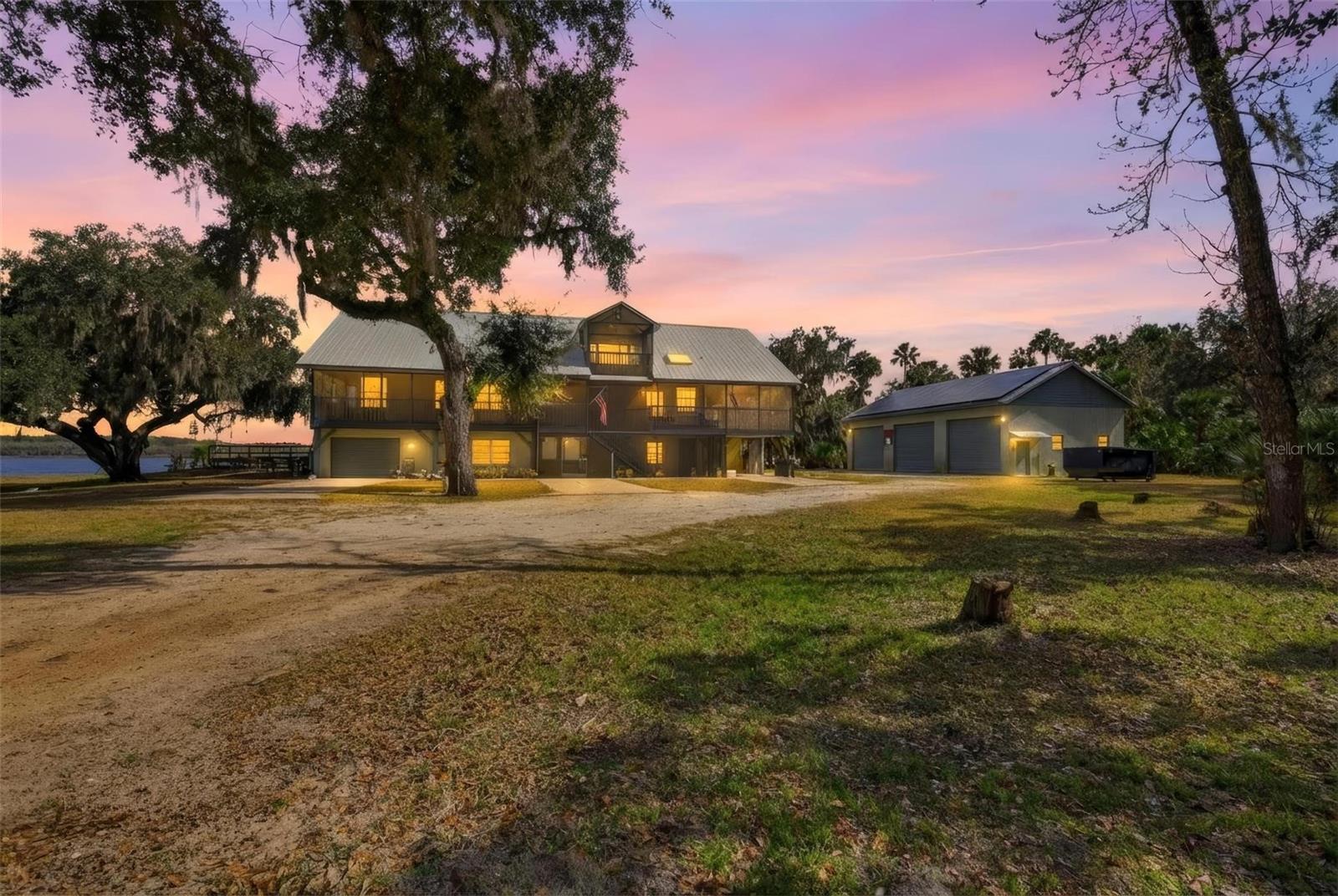 Private 10-acre estate in Osteen built for space, strength, and flexibility. This impressive 3-story residence features durable red iron construction, allowing for incredible interior freedom since there are no traditional load-bearing interior walls. Reconfigure, open up, or redesign the layout as your needs change. Enjoy a fully screened wraparound porch, brand-new electric entry gate, elevator, and dumbwaiter for everyday convenience. The home offers primary suites on both the second and third floors, each featuring newly updated showers. A fully paid-off Tesla solar system with 4 batteries provides serious energy independence and helps keep power costs low. Outside, the property is ready for horses, hobbies, equipment, or future improvements with open pasture space and room to spread out. The detached 3-bay garage includes a car lift, engine hoist, and dedicated office, making it ideal for car enthusiasts, contractors, or anyone needing true flex space. Acreage, privacy, infrastructure, and room to make it your own, this property delivers.