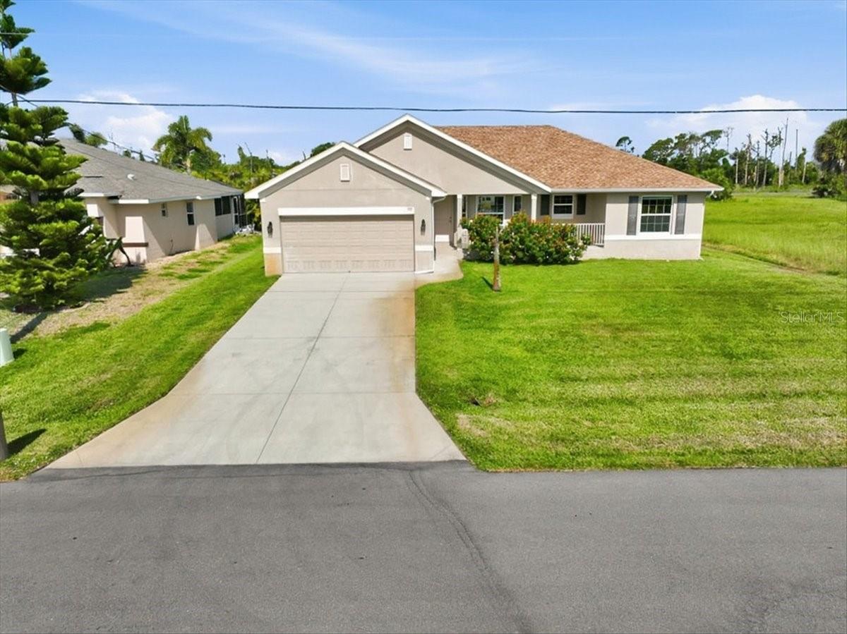 BEAUTIFUL 3 bedroom, 2 bath, 2 car garage, open floor plan home.  As you enter the home, you are greeted by the expansive living room with the dining area and kitchen to your right.  Ceramic tile throughout.  The kitchen has granite counters with a breakfast bar to seat 6 comfortably and stainless steel appliances. The living room has sliding doors that lead to the screened lanai. Perfect for enjoying your morning coffee or relaxing at the end of the day.  The backyard is fenced, adding additional privacy.  The primary bedroom has a walk-in closet while the primary bath has double sinks and a walk-in shower.  All the bedrooms have ceiling fans. Guest bath has a tub/shower combination.