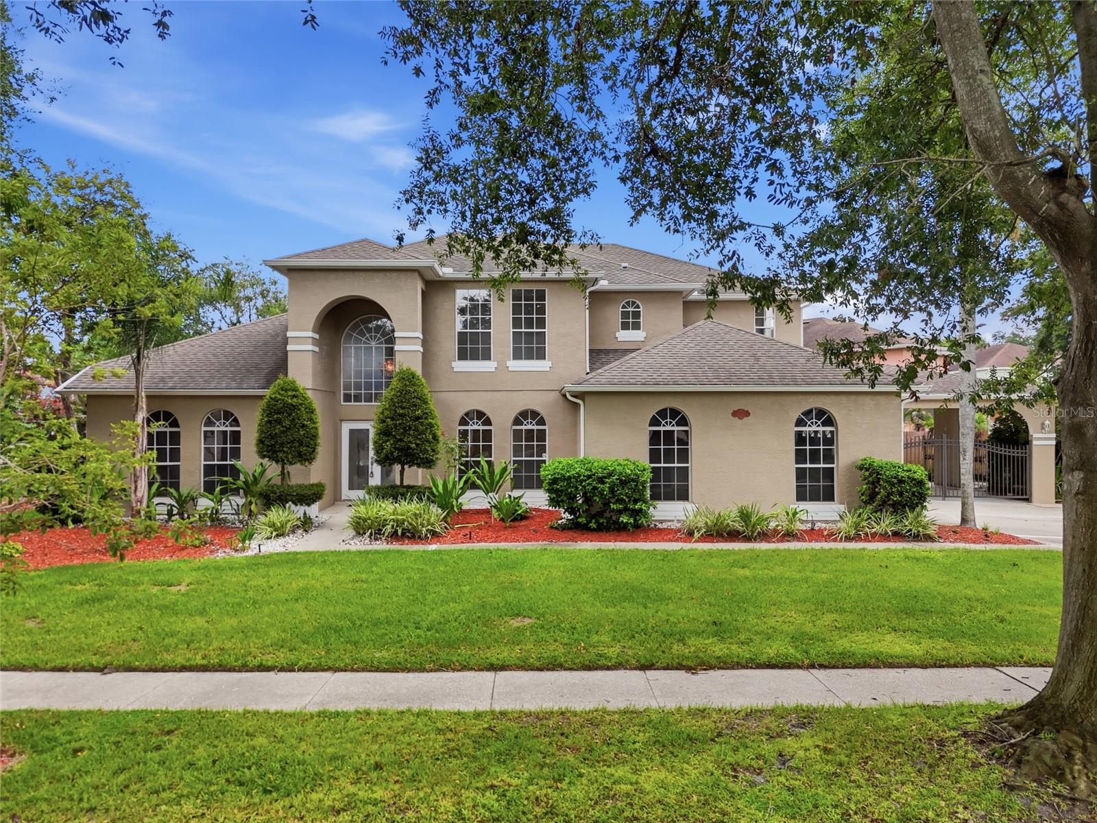 LOCATION, SPACE & OPPORTUNITY IN THE HEART OF DR. PHILLIPS! Welcome to this spacious 5-bedroom, 3-bath home offering nearly 3,000 square feet of living space in the desirable Sand Lake Cove community—just minutes from everything that makes Dr. Phillips one of Orlando’s most sought-after areas. Situated on an oversized lot, this two-story home offers the space, layout, and location that are increasingly difficult to find, along with an incredible opportunity for the next owner to update and make it their own. Step inside to soaring 17-foot ceilings and an open floor plan filled with natural light, creating an impressive sense of space from the moment you enter. The home features generously sized bedrooms, three full bathrooms, modern kitchen cabinetry, a NEW HVAC system installed in August 2025, updated irrigation, refreshed landscaping, and flexible living areas designed to accommodate a variety of needs. Out back, an extended screened and tiled patio overlooks a private garden setting with a walkway and fountain, while the additional sunroom offers flexible space for a home office, gym, sitting area, or playroom. Beyond the home itself, the location is the real standout—enjoy convenient access to Dr. Phillips’ renowned Restaurant Row, Bay Hill, International Drive, Universal Orlando, Walt Disney World, SeaWorld, premier shopping and entertainment, major roadways, and highly regarded local schools. Whether you’re looking for the space to grow, the opportunity to create your own vision, or simply a large home in an established Dr. Phillips neighborhood, this property delivers something you can’t renovate or recreate: an exceptional location. Schedule your private showing today and discover the possibilities.