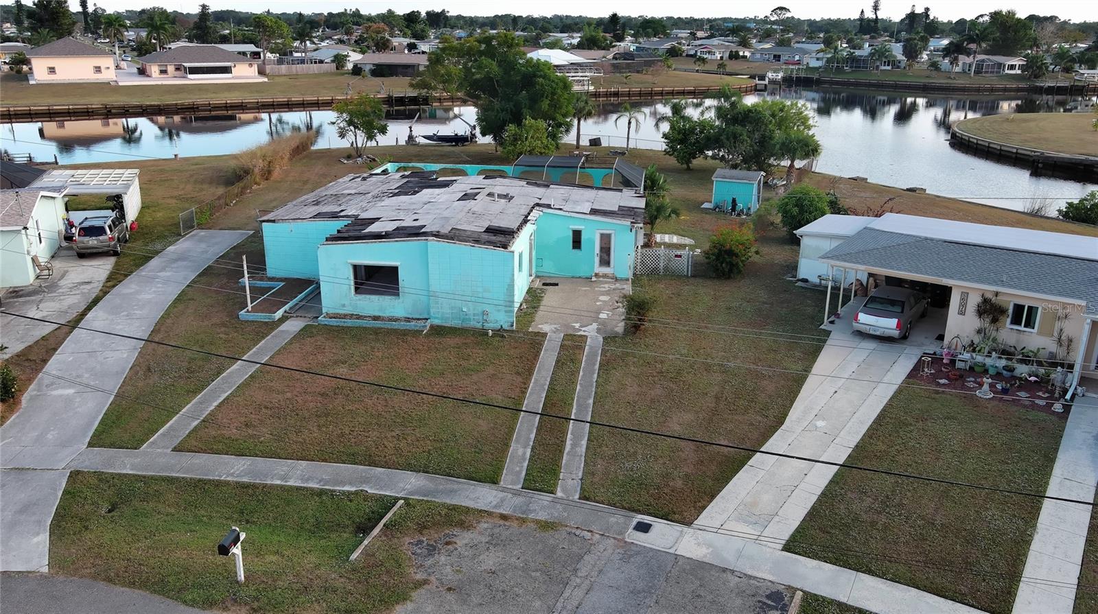 Discover an exceptional opportunity to build your dream home on this spacious 0.57-acre waterfront lot in a prime North Port location. Recently rezoned to AC-1 (Activity Center 1), the property is positioned within an area intended to support a mix of residential, commercial, and service-oriented uses, subject to city approvals, development standards, and site plan review. The property includes an existing uninhabitable structure, giving you a fresh start to design and build a home that fits your vision. With approximately 200 feet of seawall, the lot overlooks a peaceful canal connected to the Big Slough Canal and the Myakka River.  Ideal for kayaking, canoeing, and enjoying the natural surroundings. Mature fruit trees enhance the setting, adding both charm and character to the property. Two boat davit cranes are also on-site and may offer additional value with repair or replacement. Conveniently located near parks, golf courses, shopping, dining, and the well-known Warm Mineral Springs Park, this property offers a balance of privacy and accessibility. Gulf beaches are also within a reasonable driving distance for weekend escapes. With its oversized footprint, waterfront setting, and location in one of North Port’s growing areas, this is a rare opportunity to create something truly special. All information is deemed reliable but not guaranteed; buyers and buyer’s agents should verify all details.