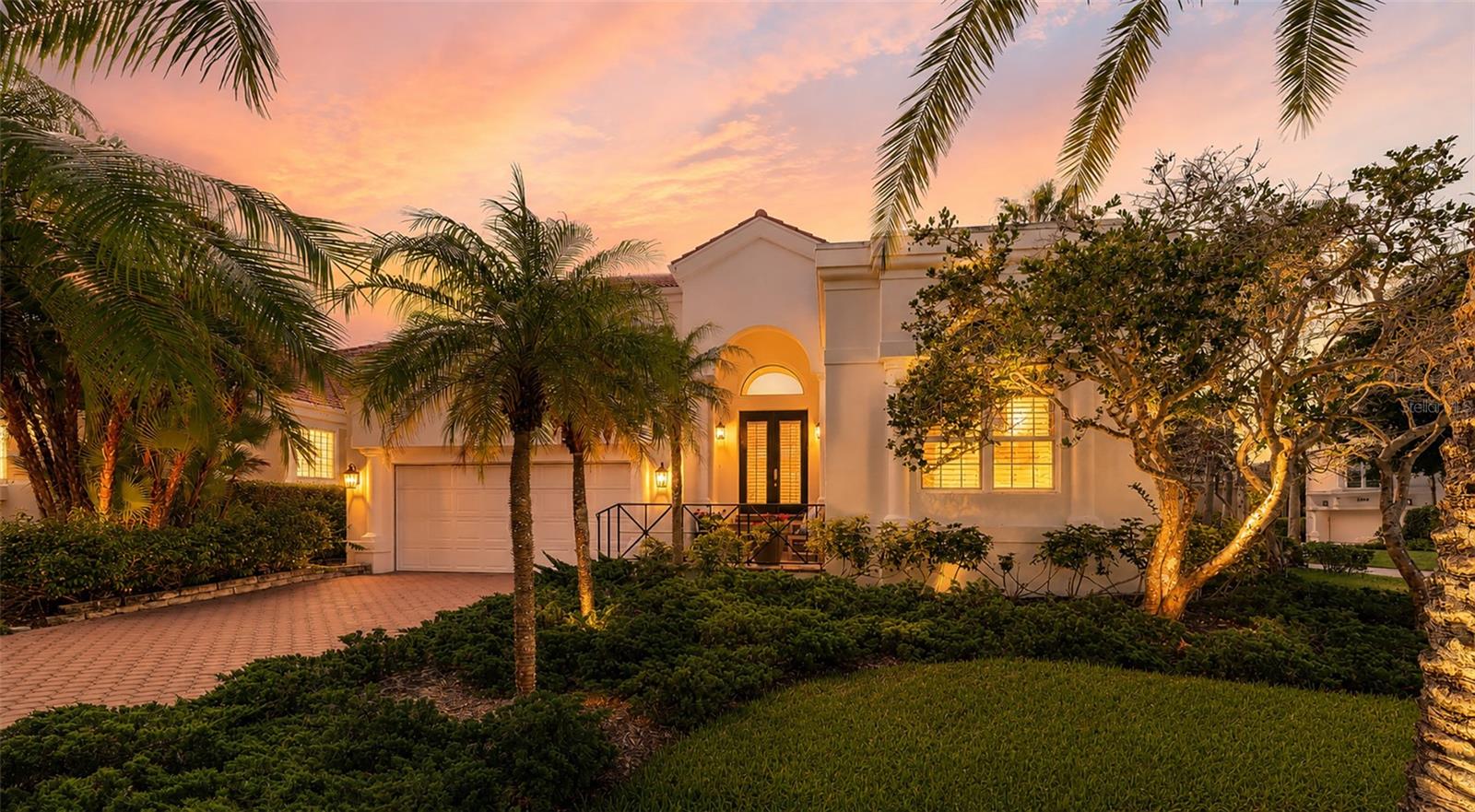 Behind the private gates of Bay Isles, this exquisitely renovated four-bedroom, four-and-a-half-bath residence in Queens Harbour presents a refined interpretation of coastal living, where timeless elegance, thoughtful design, and relaxed Longboat Key luxury come together seamlessly.

Beautifully appointed and move-in ready, the home welcomes you with an open, light-filled floor plan enhanced by hardwood flooring throughout, fresh interior paint, new baseboards, plantation shutters, new hurricane-impact windows throughout, and vaulted ceiling in the great room. Designer details elevate the interiors, including Philip Jeffries grasscloth in the foyer and Serena & Lily wallpaper in the powder bath, adding texture, warmth, and sophistication.

At the heart of the home, the newly redesigned chef’s kitchen blends classic style with everyday functionality. Features include custom shaker-style cabinetry, an oversized island, honed marble countertops, a Viking Professional Series gas cooktop, new built-in refrigerator, all new appliances, extended upper and lower cabinetry, and a charming breakfast area. The kitchen opens gracefully to the main living spaces, creating an elegant yet comfortable setting for entertaining and daily living.

The desirable floor plan offers a spacious first-floor primary suite, an additional first-level guest suite with en-suite bath, a private office, formal dining room, and expansive great room. Each space has been thoughtfully updated to feel polished, inviting, and effortlessly livable.

Outdoors, a tranquil private retreat awaits with a covered patio, pool and spa, fenced yard, and lush tropical landscaping, offering the ideal backdrop for quiet relaxation or intimate gatherings.

Queens Harbour residents enjoy the coveted Bay Isles lifestyle, including private access to the Bay Isles Beach Club on the Gulf of Mexico. Optional membership at the Longboat Key Club provides additional access to golf, tennis, boating, dining, and resort-style amenities.

Elegant, beautifully updated, and perfectly positioned within one of Longboat Key’s most desirable gated communities, this Queens Harbour residence captures the essence of refined island living.