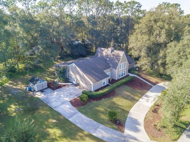 Spectacular 6 bedroom 3.5 bath pool home offering over 4,400 square ft of living space in Country Club. NO HOA! You will be impressed from the moment you drive up to this beautiful property situated on almost an acre of land among mature trees and circular driveway. Room for the family Boat, RV and all the toys! Recent upgrades include a NEW AC, Flooring, Roof, Pool Deck, & Pool Pump. The interior is just as fabulous offering vaulted ceilings with plenty of windows bringing in tons of natural light. Each room is bigger and better than the next. Kitchen has been fully updated with custom white cabinetry and granite countertops. There are TWO Master Bedroom Suites each with their own bath downstairs. FOUR Additional Bedrooms, Full Bath & Bonus Room upstairs. So many entertaining options from the elegant Formal Dining & Living Rooms to the HUGE Family/Game Room equipped with built in counters, sink, & refrigerator. The Family room does not disappoint w/ soaring ceilings, beautiful wood beams, & a dramatic floor to ceiling brick fireplace perfect for cooler winter evenings. French Doors lead out to the peaceful screened pool deck. Home is also equipped with TWO tankless water heaters. Everything you could possibly want in your forever home. Truly a one of a kind and perfect for large or multi generational families. Located 30 minutes to downtown Orlando or 30 minutes to the Atlantic Oceans white sandy beaches! Call for your private showing today!