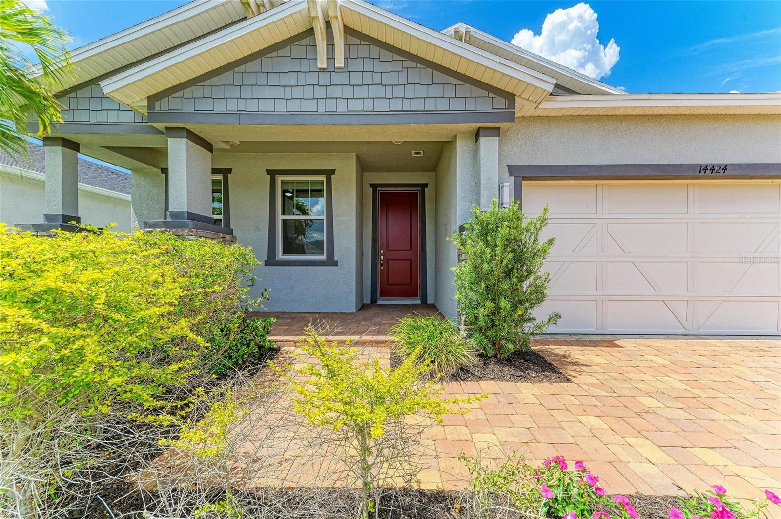 One or more photo(s) has been virtually staged. Enjoy the lifestyle of Lakewood Ranch with a low HOA of just $124/month and absolutely NO CDD fee — a rare combination in one of Florida's most sought-after communities. Why wait for new construction when this meticulously maintained 2021 KB-built home in the gated Avaunce community is move-in ready and already loaded with upgrades you won't find in many new builds? From the moment you arrive, the brick paver driveway, lush landscaping, and detailed stonework set the tone for what's inside. Step through the front door into a bright, open floor plan with tile throughout — not a single inch of carpet in this home. The kitchen is built for the way people actually live, featuring granite countertops, a double oven, generous cabinetry, and a roomy pantry. The custom floor-to-ceiling shiplap electric fireplace adds a dramatic designer touch to the main living space, while ceiling fans throughout keep things comfortable year-round. Slide open the back doors and take in the serene pond view from your extended pavered and screened patio — the perfect spot for morning coffee or evening entertaining.
The primary suite is a true retreat with a soaking tub, walk-in shower, dual sinks, and a large walk-in closet. Three additional bedrooms give you flexibility for guests, a home office, or whatever fits your life. Hurricane shutters provide peace of mind when storm season rolls around. The home sits in Flood Zone X, so no flood insurance is required. Beyond your front door, Avaunce connects you to everything that makes Lakewood Ranch exceptional — world-class dining, miles of scenic trails, boutique shopping, a vibrant community calendar that keeps life full, and easy access to I 75. The community pool is included in that low monthly HOA fee.