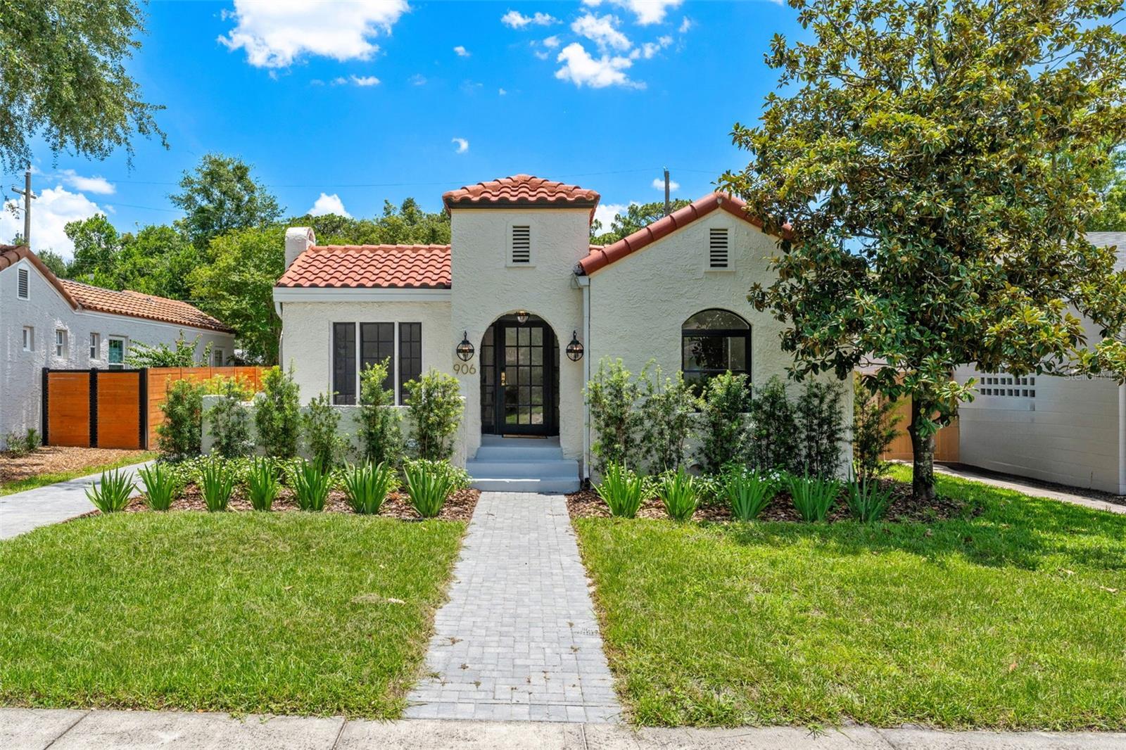 Rare, authentic, and completely captivating, this 1927 Spanish bungalow in College Park has been meticulously renovated and reinvented while preserving the character that makes homes of this era so special. From the clay tile roof, textured stucco, arched entry, black-framed windows, and pavered drive, the curb appeal is immediate. Inside, natural light fills the home through oversized windows, creating beautiful cross breezes and an airy flow between the living, dining, and kitchen spaces. Refinished hardwood floors, arched openings, designer lighting, and a statement tiled fireplace bring warmth and texture throughout. Thoughtful details remain, including windows with vintage cupboard turns and built-in cabinetry featuring vintage Eastlake T-latch hardware.

The kitchen feels both timeless and elevated with custom rift-sawn white oak cabinetry, quartz countertops, 24x48 luxe tile flooring, high-end Samsung appliances, and an induction range. Both bathrooms have been thoughtfully finished, including a spa-like shower with dual-head fixtures, body sprayer, bench seating, and refined brass details. The home also features walk-in closets, generous storage, two spacious patios, a sizable backyard, and a detached air-conditioned bonus room ideal for a home office, studio, gym, or guest overflow.

Outdoor living is a true extension of the home, with private patio spaces, room for a future summer kitchen, and a yard that feels ready for slow mornings, evening gatherings, and bringing vacation home.

Set on a beautiful tree-lined brick street just steps from Starbucks, Publix, Dartmouth Park, and the heart of College Park, 906 Stetson is a rare blend of architectural charm, modern luxury, and everyday convenience.