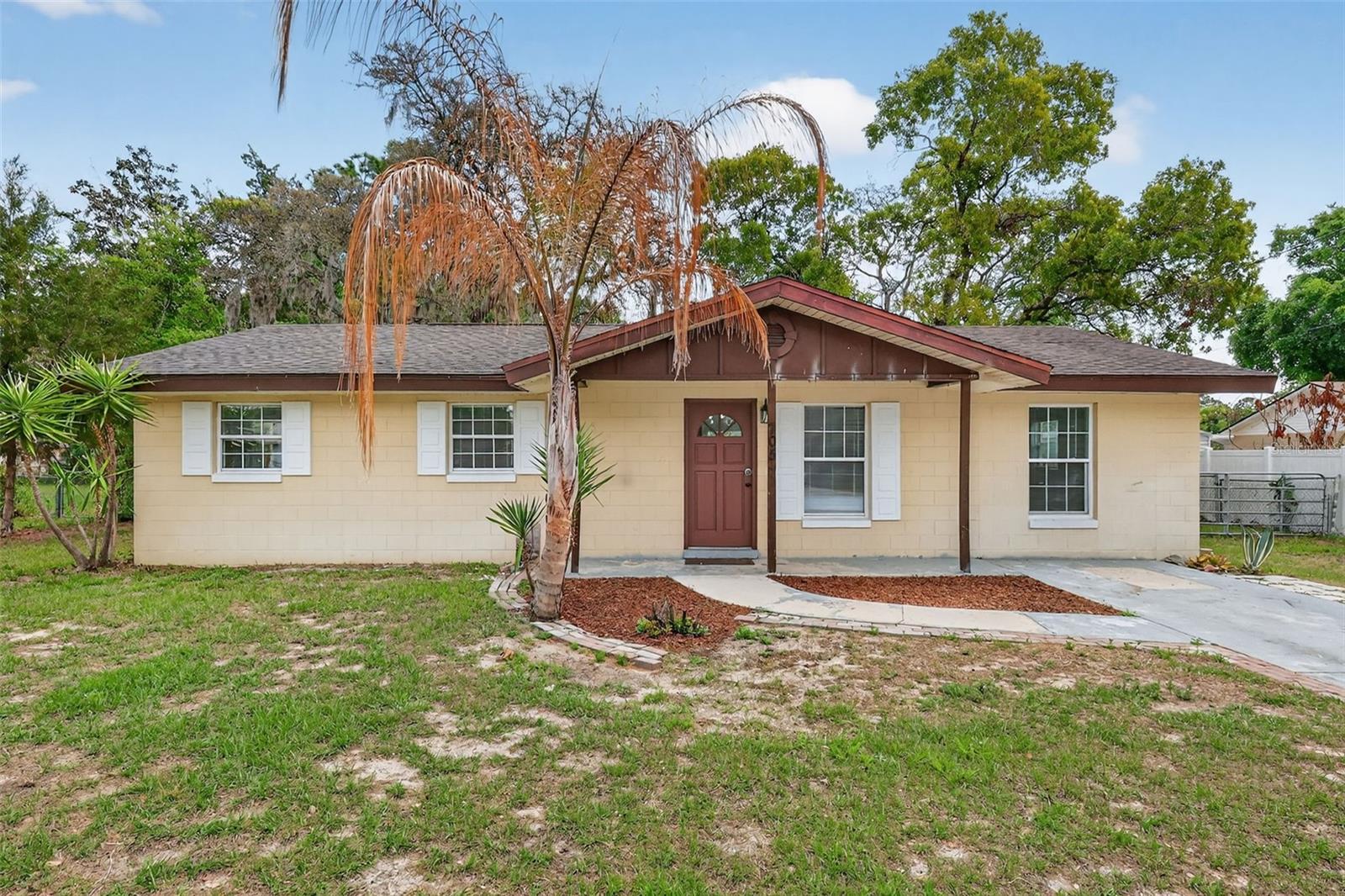 WELCOME to this 3 bedroom, 2 bathroom home in the tucked-away Park Acres neighborhood of Fruitland Park. Stop looking for someone else’s "finished" and start creating your own. This diamond in the rough is ideal for first-time buyers, flippers, or landlords. Step into an open floor plan with plenty of afternoon sun, where practicality meets convenience with an INSIDE LAUNDRY/UTILITY/MUD ROOM that leads to your private backyard with COMPLETE PERIMETER FENCING! What’s YOUR VISION? Open space for pets to play? A gazebo? Gardening? A fire pit? 705 Mike Avenue has been waiting for someone to love it.  BIG-TICKET ITEMS ALREADY DONE: NEW AC in 2022 - stay cool through the Florida summers. NEW FLOORING in 2023 - modern, durable, and stylish throughout. RENOVATED BATHROOMS in 2023 - updated and ready for your finishing touches. KITCHEN UPDATES in 2023 - stainless steel LG appliances. THE “FUN” STUFF IS UP TO YOU - A BLANK CANVAS FOR YOUR LIFE!  Add instant equity with your DIY project skills. PRIME LOCATION & VALUE: Priced to move quickly, this home offers the peace of a secluded community while remaining minutes from nearby parks, schools, shopping, the library, public transportation, and local favorite Mystic Ice Cream. Enjoy easy access to the best of Fruitland Park, Leesburg, and Lady Lake, with Brownwood’s Paddock Square only 8 miles west. 705 Mike Ave is ready for its next chapter—are you?