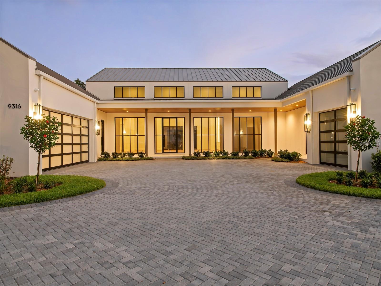 Virtually Staged. An exceptional new construction offering within The Gardens of Isleworth, this newly completed residence by premier custom homebuilder Goehring & Morgan presents a rare opportunity to enjoy the ease of modern luxury within one of the world's most distinguished golf club communities. Thoughtfully designed and never lived in, the home combines timeless architecture with professionally curated interiors by Design Specifications, creating a refined retreat where every detail has been carefully considered. Spanning more than 5,400 square feet, the five-bedroom residence unfolds through a series of light-filled living spaces distinguished by bespoke millwork, tailored cabinetry, and a sophisticated palette of designer-selected finishes. Clean architectural lines and expansive gathering areas create an atmosphere that feels both grand and inviting, while thoughtfully integrated design elements elevate everyday living. Throughout the home, custom cabinetry conceals a fully integrated Sub-Zero, Wolf, and Cove appliance suite, allowing the chef's kitchen to maintain its beautiful aesthetic while delivering professional-grade performance. Well-appointed entertaining spaces nearby transition effortlessly from intimate family gatherings to larger celebrations.Private bedroom retreats offer comfort and tranquility, while spa-inspired baths showcase carefully selected finishes, fixtures and materials that evoke exceptional craftsmanship. The primary suite serves as a sanctuary unto itself, complete with a private beverage bar and thoughtfully designed spaces that encourage both relaxation and retreat.Beyond the interiors, walls of glass open to an inviting outdoor environment designed for year-round enjoyment. A fully equipped summer kitchen anchors the outdoor living experience, creating a natural extension of the home's entertaining spaces and providing the perfect backdrop for gatherings beneath Florida's sunshine and tropical climate.Surrounded by lush landscaping, sparkling water features, and the natural beauty that defines The Gardens of Isleworth, the residence enjoys a setting that feels both private and refined. Residents of Isleworth enjoy access to a lifestyle renowned for championship golf, world-class amenities, exceptional service, and a level of privacy rarely found. Combining the freshness of brand-new construction with the prestige of an established luxury community, this is more than a home, it is an opportunity to experience Isleworth at its finest.