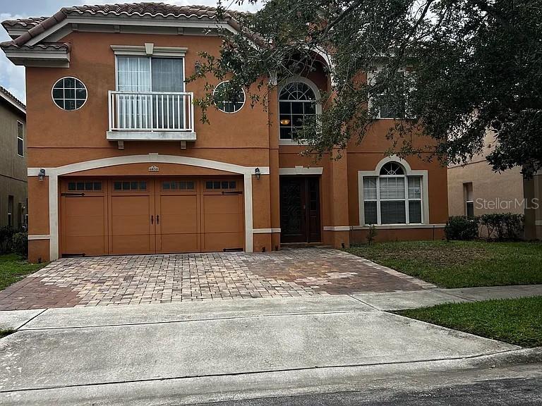 Outstanding long-term investment opportunity in one of Orlando’s most desirable and stable residential corridors. This beautiful two-story home is filled with natural light and offers a flexible, functional layout ideal for families, professionals, or long-term tenants seeking comfort and convenience.

The first floor features a spacious living and family room at the entrance, newly installed travertine flooring, and a striking limestone half wall illuminated with LED lighting — a modern design element that enhances appeal and durability. A private downstairs bedroom with an attached full bathroom provides versatility for guests or multi-generational living.

The kitchen offers extensive storage, including additional space near the garage entrance, making everyday organization effortless. Upstairs, the master bedroom overlooks the private patio and garden, accompanied by three additional bedrooms and an upstairs laundry room for maximum convenience.

Exterior highlights include a paver driveway with parking for up to five vehicles (two in the garage and three in the driveway), a private garden patio, and a Spanish tile roof that adds character and long-term durability.

Located in a gated community, offering enhanced privacy and security — a major advantage for long-term occupancy and property value stability.

Unmatched location: the home sits right next to Universal Studios, with Volcano Bay so close you can step outside the front door and see the water slides. This proximity creates exceptional long-term demand and strong appreciation potential.

Situated in the heart of Dr. Phillips, one of Orlando’s most sought-after neighborhoods, known for top-tier schools, world-class dining, major attractions, and consistent property value growth.