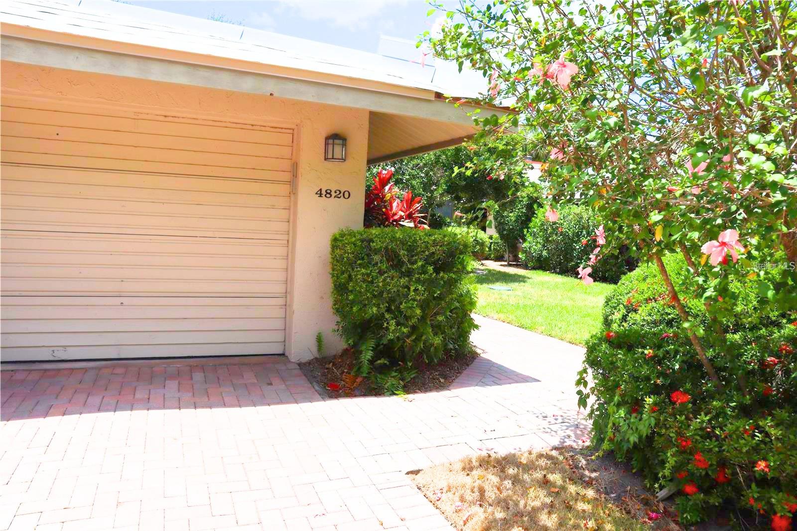 Welcome to one of The Landings' best-kept secrets. Tucked inside the intimate Carriage House community, this 2-bedroom, 2-bath plus spacious den residence delivers the feel of a single-family home wrapped in the ease of maintenance-free living and its move-in ready.  Inside, tile flooring flows throughout, anchoring a bright, open layout that feels larger than its footprint suggests. The updated kitchen impresses with a modern aesthetic, solid surface counters, and finishes that feel fresh and intentional, not dated. Both bathrooms have been thoughtfully remodeled, featuring solid surface counters and elegant tile enclosures. A wood-burning fireplace adds warmth and character, making this home as livable as it is lovely. The very spacious den offers the flexibility to serve as a home office, guest room, or hobby space, whatever your lifestyle calls for. An additional den space provides even more room to spread out, work, or create.  Your private one-car garage sits just beyond a charming paver driveway shared with only one neighbor — a quiet, neighborly setup that feels nothing like a typical condo. When it comes to outdoor living, this home truly delivers: an expansive screened-in patio sets the stage for year-round enjoyment, while a separate open-air patio offers a sun-drenched spot to relax, garden, or simply soak in the Florida lifestyle.  Peace of mind comes standard: a brand-new 2026 roof means this home is as solid as it is stylish. Offered unfurnished and ready for immediate occupancy.  Residents of Carriage House II enjoy access to a beautiful pool and clubhouse, all set amid lush, manicured grounds surrounding a tranquil lake with fountains, turtles, and ducks. Membership to The Landings Racquet Club is available but not included or required — a wonderful option for those who want the full lifestyle package. The Landings' coveted location west of the Trail puts everything within easy reach.