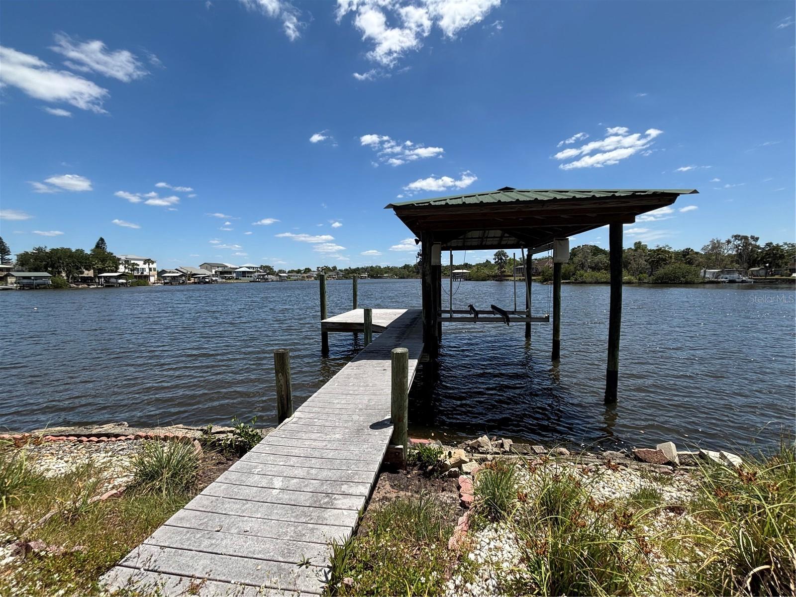 Waterfront buildable lot on the Alafia River with easy access to Tampa Bay.  Exceptional opportunity to build your dream home on a prime waterfront lot along the scenic Alafia River.   Just minutes from Tampa Bay by boat, this property is ideal for boating and waterfront living enthusiasts.  Features of this lot:  70 feet of direct river frontage with easy access to open water, covered boat dock with 10,000 pound boat lift.   The property also has an RV carport and gazebo by the water.   Enjoy the perfect blend of privacy, nature, and quick access to some of the best boating waters on Florida’s Gulf Coast.  Peaceful setting with convenient access to all Tampa Bay shopping and entertainment.