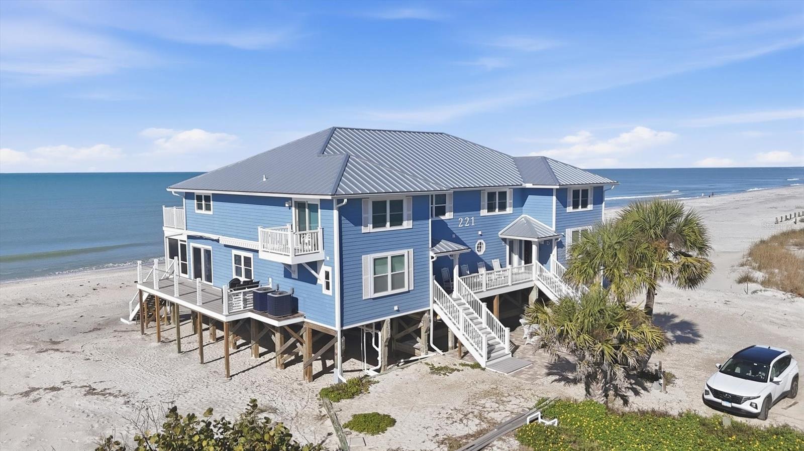 DIRECT BEACHFRONT TOWNHOME on "Palm" Island!
If you’re dreaming of an island getaway with your toes in the sand instead of the snow, this beautifully renovated end-unit townhome delivers the ultimate coastal escape. Located on magical Palm Island, along the sparkling Gulf of America, you’ll enjoy front-row seats to breathtaking sunsets and miles of pristine, shell-strewn white-sand beaches.

This 2-bedroom, 2.5-bath residence has been thoughtfully updated inside and out and is truly move-in ready. Features include hurricane-rated windows and sliders, a 2025 standing-seam metal roof, Hardy Board siding, newer A/C, plumbing, electrical, and appliances, plus an open, inviting floor plan filled with natural light. Step outside to an expansive and private beachfront deck—perfect for entertaining, dining, or simply soaking in the views. The primary suite also offers its own private deck, ideal for savoring nightly sunsets.

Whether you’re seeking a personal island retreat or a high-performing investment property, this townhome checks all the boxes and has excellent rental potential.

Palm Island is a bridgeless barrier island accessible by a short car ferry ride, preserving its laid-back Old Florida charm. Once here, enjoy golf cart rides, kayaking, boating, fishing, biking, and long, peaceful beach walks—far from the hustle and bustle of everyday life.