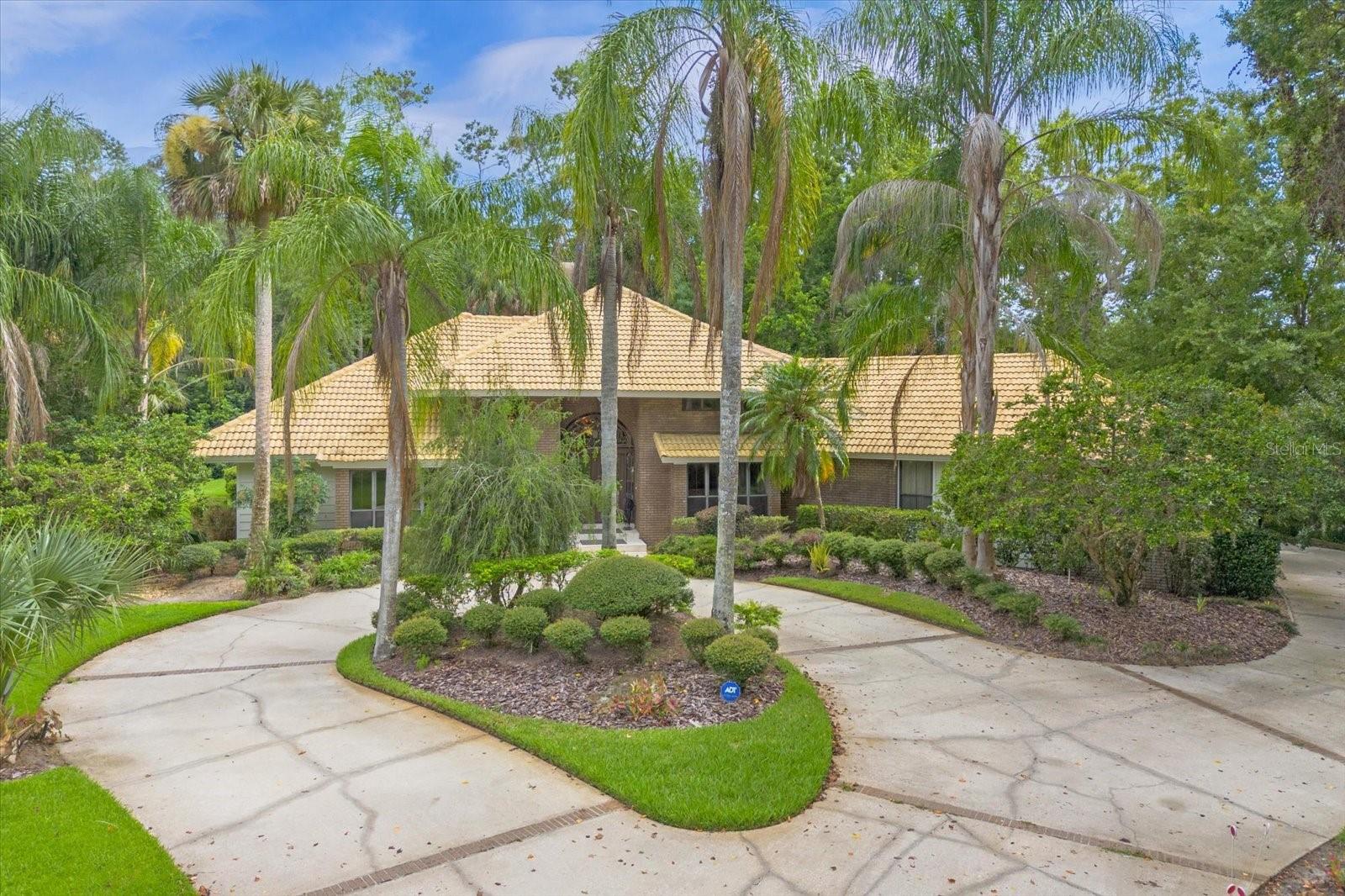 Welcome to the exquisite Wingfield Reserve, where luxurious living meets top-rated schools. This custom-built 4-bedroom, 4-bathroom home is an architectural masterpiece, showcasing exceptional craftsmanship and attention to detail throughout.
Upon entering, you'll be greeted by 14' volume ceilings adorned with stunning custom crown moldings that add an air of elegance to the space. The seamless fusion of wood and marble floors further enhances the home's beauty, creating a warm and inviting atmosphere.
An executive office with built-ins provides the perfect space for productivity and organization, making it ideal for those who work from home, or  it can also be used as  another bedroom.
The family room becomes a focal point with its impressive brick wood-burning fireplace, stretching from floor to ceiling. It's the perfect spot for cozy gatherings and adds a touch of rustic charm to the overall design.
The spacious kitchen is a chef's dream, featuring a center island with a breakfast bar, perfect for casual meals and entertaining guests. The separate breakfast nook allows you to enjoy your morning coffee while overlooking the lush landscaping and custom outdoor lighting.
The master bedroom is a sanctuary of tranquility, with wood floors adding warmth to the space. The master bath is designed for relaxation, boasting a Jacuzzi tub, a separate shower, and double vanities, creating a spa-like experience in the comfort of your home.
Step outside to the covered porch with a screen enclosure, offering a perfect spot for outdoor enjoyment without the hassle of insects. The recently updated pool with solar heating and spa is an oasis of serenity, providing an ideal setting for unwinding after a long day or hosting memorable gatherings with family and friends.
The 3-car rear side entry garage with a circular drive not only adds convenience but also enhances the home's curb appeal, making a lasting impression on visitors.
Situated on over 1 1/2 acres of lush landscaping, this private lot provides ample space for outdoor activities and the potential for further enhancements to create a truly remarkable outdoor living space.
To elevate this already spectacular home, consider adding personalized touches to make it uniquely yours. Whether it's through interior design choices, landscaping additions, or technological upgrades, you have the opportunity to take this property to even greater heights.
This home in Wingfield Reserve is a must-see, offering a harmonious blend of elegance and comfort. With a little imagination and thoughtful improvements, you can make this residence an even more fascinating and captivating place to call home.