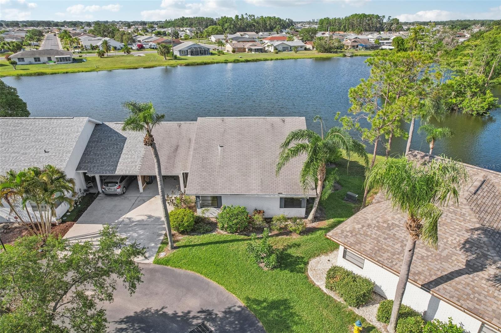 Welcome to this stunning 2-bedroom, 2-bath waterfront home tucked away on a quiet cul-de-sac street! Enjoy peaceful water views from nearly every room, with tall ceilings, expansive sliders, and an abundance of windows that fill the home with natural light. Beautiful laminate flooring flows throughout the spacious layout. The large primary suite features a walk-in closet and a private bath, creating a comfortable retreat. The generous kitchen offers warm wood cabinetry, a pantry, and plenty of counter space—ideal for both everyday living and entertaining. Additional highlights include a separate laundry room and a screened-in lanai, perfect for relaxing while taking in the tranquil surroundings. You’ll love Sun City Center with its amazing facilities, pools, and clubs just waiting for you to enjoy. Nestled between Sarasota and Tampa, this location offers a convenient ride to airports, great shopping, dining, and professional entertainment. With easy access to award-winning, sandy beaches, this home provides the best of all worlds without the stress of big city life. Leave it all behind and enjoy your new life here in one of Florida’s most affordable 55-and-better communities! A rare gem for serene waterfront living!