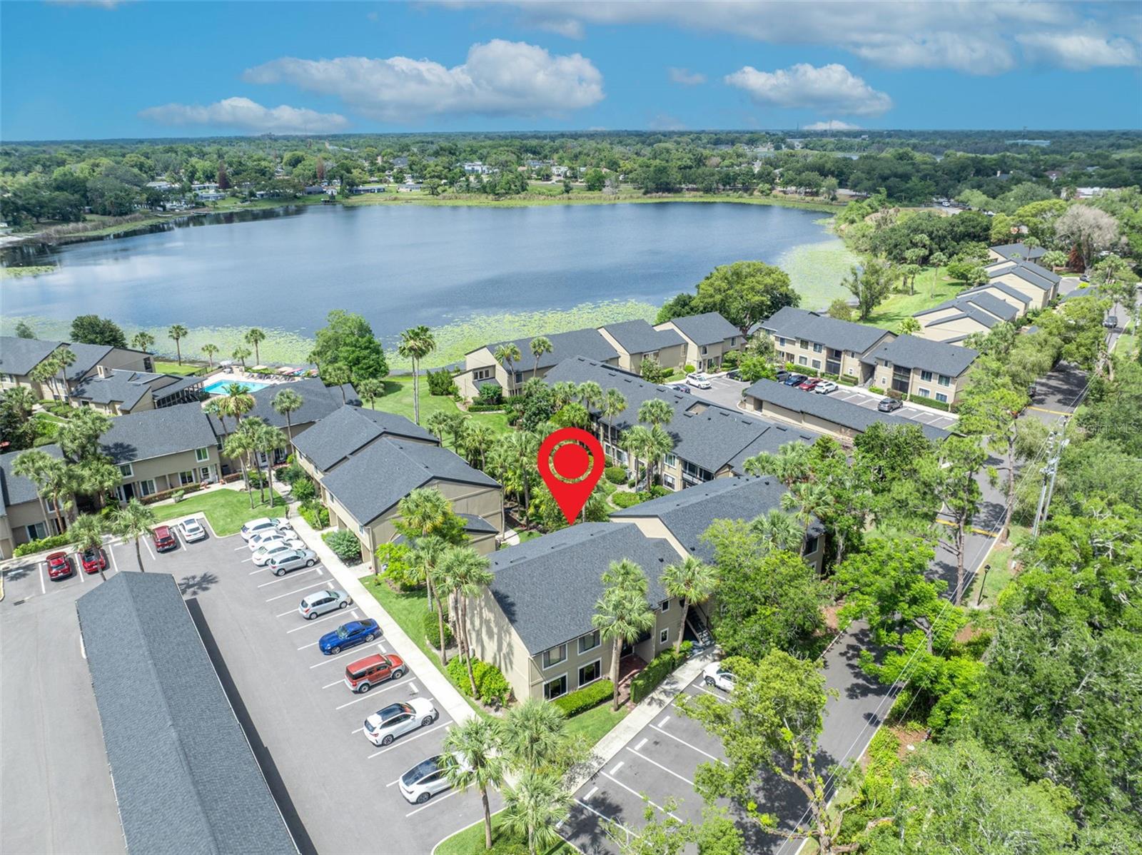 One or more photo(s) has been virtually staged. Tucked away in this delightful lakefront community this beautifully renovated GROUND FLOOR condo offers so much, including a 2 PARKING SPACES - one is a deeded carport and the other is an open assigned parking spot... And there is a separate storage closet too! Situated on one level, this condo overlooks the charming grounds and a peek of Lake Faith from the living areas and porch. Inside is a treat for sure with a large open living and dining room layout that is light and bright. The unit has a luxury vinyl plank flooring throughout most of the unit and tile flooring in the kitchen and baths. The kitchen is updated with granite countertops and plenty of cabinetry. Off the living room is an expansive back porch that has tile flooring and was recently updated with newer windows and entry door (2024) .... And off the dining area is a charming, covered porch. So, lots of areas to enjoy day to day or if you like to entertain.  The master bedroom is a spacious size and also opens to the back porch… You will love the master bath - completely redone with a large shower, a stylish vanity with ample storage as well as a make-up vanity and a generous walk-in closet. The 2 additional bedrooms are both a good size with great closet storage. Other notable features are the inside laundry closet with open shelving and newer LG washer and dryer (2024) and the custom shades installed in the living areas and bedrooms (2023). Along with these upgrades, there have been system updates including new hot water heater (2015), new AC (2016) and replumbed (2013).  This complex offers a private, tranquil atmosphere and has terrific amenities including a gated entrance, clubhouse, and pool. And the location couldn’t be more convenient, with easy access to I-4 as well as a new retail and restaurant development within a short stroll.  This is one not to miss!