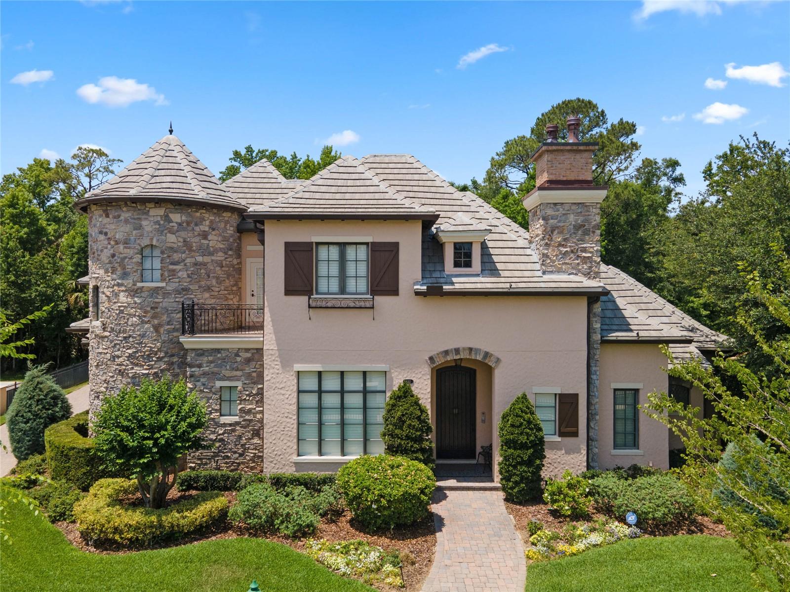 One or more photo(s) has been virtually staged. This once in a lifetime Castle Works  home  is Absolutely Amazing with all the beautiful upgrades and little secret extras.  This home is so versatile from cozy nights in the theater watching your favorite  movies/shows to entertaining.  The incredible bar area along with the custom built outdoor kitchen and pool will amaze your guests.   3 of the 4 bedrooms in the main house are ensuites and one has a full bath right around the corner,  along with 5 full baths and 1 half bath (main house) leaves you plenty of room for you the homeowner and friends. The garage apartment is fully contained and and gives you another bedroom and full bath.  Tile roof is 3 yrs old with a warranty.    Freshly repainted inside.  Five air conditioners have all been replaced along with the hot water heater.  Amazing theater has had new equipment  and extra speakers put in as well.  Kitchen is a gourmets happy place with upgraded appliances and a huge walk in pantry. Handy butlers pantry with sink and wine refrigerator adjacent to the formal dining  area. 
This amazing castle has natures beautify behind the house that will remain untouched.  As you sit out in  the screened patio you can enjoy the deer as they walk behind this home to their next adventure.