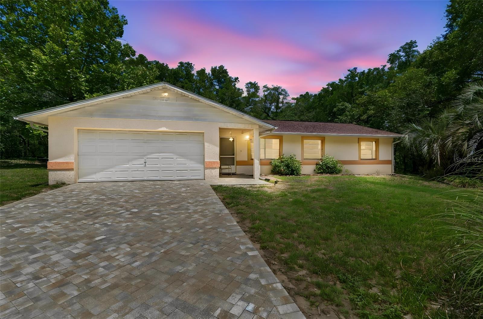 Welcome to this private and spacious 3-bedroom, 2-bathroom home with a 2-car garage, perfectly tucked away in the desirable Inverness Highlands North area. Surrounded by peaceful wooded views with no immediate neighbors in front, behind, or on either side, this property offers a rare sense of privacy while still being conveniently located less than a mile from the Gulf-to-Lake Highway for easy access to shopping, dining, and everyday conveniences.

A brand-new paver driveway creates a beautiful first impression as you arrive at this solid concrete block and stucco home featuring a NEW ROOF installed in January 2026, with the transferable warranty conveying to the new owner. Best of all, there is NO HOA, giving you the freedom to bring your RV, boat, 4-wheelers, and other recreational toys with plenty of room to park them on the spacious property.

Inside, the thoughtfully designed layout begins with a welcoming family room that flows seamlessly into the kitchen and dining area before opening into a bright living room highlighted by a stunning fireplace added by the seller, creating a warm and inviting focal point for gatherings. The kitchen offers newer cabinetry, a functional island counter, soft-close drawers, recessed LED lighting, updated fixtures, and a ceiling fan for added comfort. Fresh neutral interior paint and upgraded lighting throughout brighten the living spaces while still leaving opportunities for the next owner to add their own personal touches.

French doors from the living room lead to a screened lanai overlooking serene wooded surroundings, creating the perfect place to relax and enjoy Florida living in privacy. The expansive primary suite is tucked away in its own bedroom wing and features direct access to the lanai, a massive walk-in closet, and an oversized en-suite bathroom complete with a jacuzzi tub and separate walk-in shower. Two additional bedrooms provide flexibility for guests, family, or a home office.

The front of the lot also benefits from a public easement that provides convenient access to and from the property. Combining seclusion, space, and accessibility, this hidden gem is the perfect opportunity for buyers seeking comfort, privacy, and the freedom of no HOA living in Inverness.