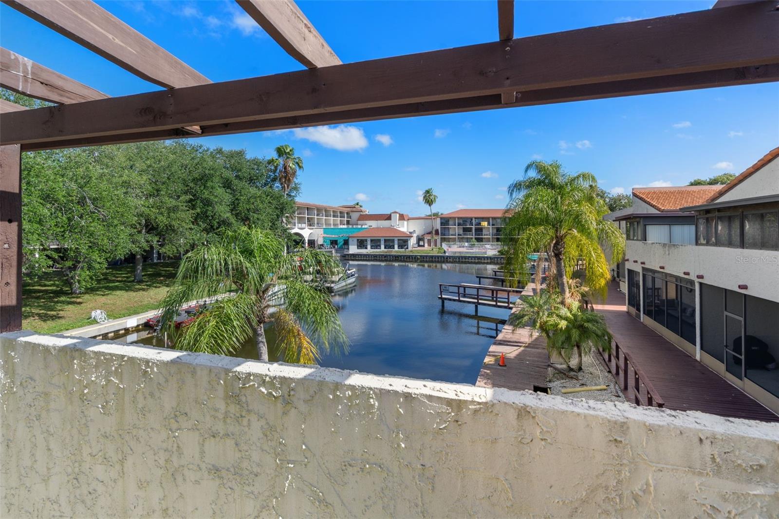 Waterfront Condo with Boat Slip and Airbnb Friendly! Use it as you like either full time, as a seasonal renter or airbnb/vrbo investor. Take your pick. Situated on a canal leading directly to Lake Tarpon! This fully furnished 1-bedroom, 1-bath condo which includes a converted second bedroom area and new windows features vaulted ceilings and beautiful views. Enjoy views from the spacious private balcony. The vaulted ceilings create an open, airy feel, while the kitchen features a breakfast bar overlooking the living area. Laminate and tile flooring throughout make maintenance easy. This unit is truly move-in or rent-ready: One of few communities that allows AIRBNB with few restrictions. NO WAIT PERIOD TO START RENTING and WEEKLY RENTALS ALLOWED. The owners rent the condo every January - April for $3k per month. Pets allowed as well, Low monthly HOA of $475 which includes basic cable, internet, sewer/water and trash. AC 2019, Water Heater 2024. No elevator. Laundry center is located by pool. A stackable washer and dryer can be plumbed and added to the condo quite easily. Many 1 bedroom owners have added them. Enjoy the sparkling pool and heated hot tub. There is also a community clubhouse with kitchenette. The boatslip to this unit is labeled 1-201 and can be seen directly off the balcony. Boat can be put in at Anderson Park up the street. Minutes from Historic Downtown Tarpon Springs where you can enjoy wonderful Restaurants, Shopping, The First Friday Celebrations and the Greektown Spring Docks. Fred Howard Beach and Sunset Beaches just 6 miles away. Additionally, it has been determined by FEMA and the County that the community is not IN A FLOOD ZONE. We have a LOMA Letter; see attachments. THE COMMUNITY WAS NOT FLOODED BY THE RECENT HURRICANES. The water level of the lake is controlled by the county, so when a storm is coming they let the water out. CASH ONLY OFFERS! OR DCSR LOAN.