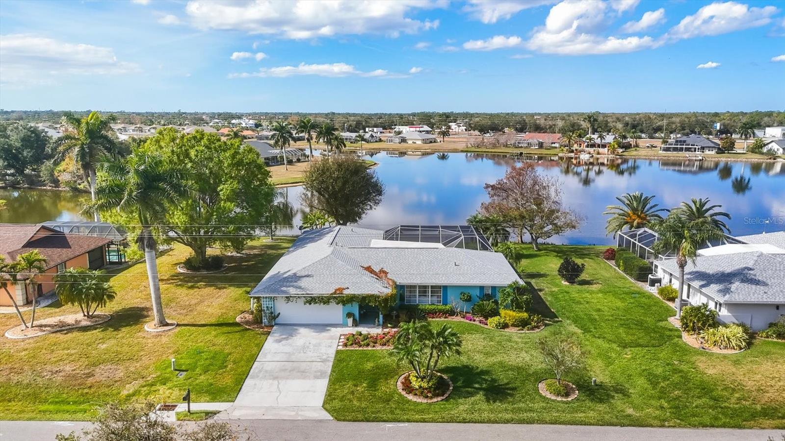 PRICE IMPROVEMENT!!! Experience the best of Florida living in this highly sought-after 3-bedroom, 2-bath pool and spa home with a 2-car garage, located in the premier Lake Suzy subdivision of DeSoto County. Set on a picturesque lakefront lot with its own private boat dock, this property offers the perfect blend of comfort, relaxation, and waterfront enjoyment. Ideally located just minutes from shopping, dining, and convenient access to the I 75 corridor, the home provides both everyday convenience and the tranquility of a peaceful neighborhood. Inside, a desirable split floor plan offers spacious living areas, complemented by two oversized sliding doors that fully open to the pool area—creating a seamless indoor outdoor living experience ideal for entertaining. This meticulously maintained home boasts numerous recent upgrades, including a new roof (2024), a new $20,000 septic system, freshly painted interior and exterior, and luxury vinyl plank flooring throughout the main living areas. The upgraded kitchen features quartz countertops, a travertine backsplash, and stainless steel appliances, with refurbished cabinetry accented by new hardware. Additional improvements include new ceiling fans and lighting, a remodeled primary shower, and all-new ductwork. Step outside to a picture screen lanai offering unobstructed views of breathtaking lake sunsets, along with a new pool pump and convenient boat dock for easy access to the water. The garage includes a versatile 8' x 9' workshop area, while an air-conditioned interior storage closet provides ideal space for valuables or seasonal items. An extra-large laundry room adds even more interior storage.
Surrounded by mature landscaping and showcasing stunning lake views, this exceptional home embodies the quintessential Florida lifestyle. A welcoming entrance adorned with a lovely Florida Flame Vine adds the perfect finishing touch. Don’t miss this rare opportunity—this lakefront property is truly a standout in today’s market.
