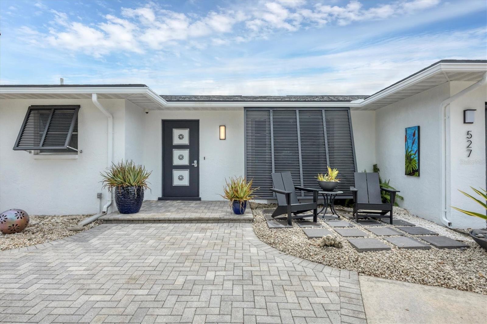 This home is special! Welcome to this beautifully updated two-bedroom, two-bath pool home featuring a one-of-a-kind pool cabana—ideal as a home office, art studio or flex space. Inside, you’ll find a wide-open great room floor plan with built-in cabinetry, new flooring, and a chic, neutral palette. The kitchen and both baths were remodeled and provide modern finishes and a fresh, stylish look, including custom closet systems for organized storage. The backyard is designed for entertaining with an oversized lanai space featuring a large free-form pool that was resurfaced/re-tiled in 2022, complete with a new electric heat pump and pool pump. The pool cabana, added in 2022 and equipped with its own mini-split air conditioner, creates a space for work or play. From the main home, view and access the dramatic outdoor shower space surrounded by custom tropical artwork with elevated hardware for the ultimate outdoor shower experience. The property is fully fenced for privacy and includes an oversized garage for all your extras. This home has been thoughtfully updated with a newer roof (2021), new ductwork (2021), updated plumbing with a Manabloc system, new water heater, and solar panels powering the entire house added in 2021 to keep those electrical bills low. Additional improvements include a new air-conditioning system 2022, updated electrical with an outlet for a generator, remodeled kitchen and baths, radiant barrier was added to the attic, and some impact windows were added for peace of mind. In Venice East, a community with a voluntary HOA and no deed restrictions, you’ll have the freedom to bring your boat, RV and the extras. All of this is just minutes from Wellen Park, downtown Venice, Gulf beaches, dining and shopping. This jewel won’t last long—schedule your showing today!