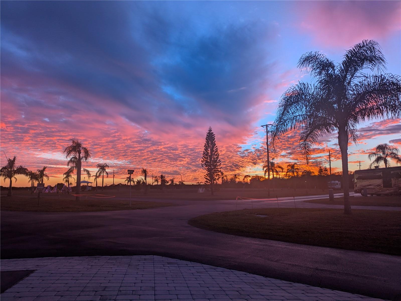 Welcome to Units 1 and 2 at Paradise Park, a gated, 55+ Class A Motorhome or Airstream only, pet-friendly community in Punta Gorda, FL. This is a rare opportunity to own two connected, deeded RV lots offered together, providing an exceptional combination of privacy, space, and stunning views.
Unit 1 is a premium corner lot with pond views and beautiful sunset scenery. As the first site visible when entering onto Paradise Boulevard, the location offers both privacy and exceptional curb appeal. Unit 1 features an oversized layout with a large Florida Room and is sold fully furnished, including a separate dining room. Enjoy unobstructed sunset views from every window. Recent updates include new mini-split A/C, new landscaping, and pavers. The lot also includes a separate parking spot plus a shed equipped with a toilet, shower, sink, washer, dryer, and refrigerator.
Unit 2 provides additional storage and function, featuring a shed with a partial bathroom. The two lots are beautifully enhanced with a raised flower bed connecting the properties.
The annual lot fee for each unit includes water, trash, sewer, and lawn maintenance, along with access to the community’s full social calendar. Residents own their deeded lot and share an equal interest in the community’s beautifully maintained 136 communal acres, recreational facilities, and the privately operated water and sewer treatment systems.
Paradise Park Amenities Include
FREE 9-hole golf course, clubhouse, laundry facilities, heated pool, pickleball, bocce, shuffleboard, fitness room, billiards, 5-acre fishing lake, dog park, trailer storage area, on-site mail room, library, community fire department, woodworking and metal shops, and many activities including social golf, tournaments, yoga, water aerobics, cards, karaoke, bingo, crafts, dance classes, pool tournaments, and entertainment nights.
Don’t just buy a lot—buy a lifestyle.