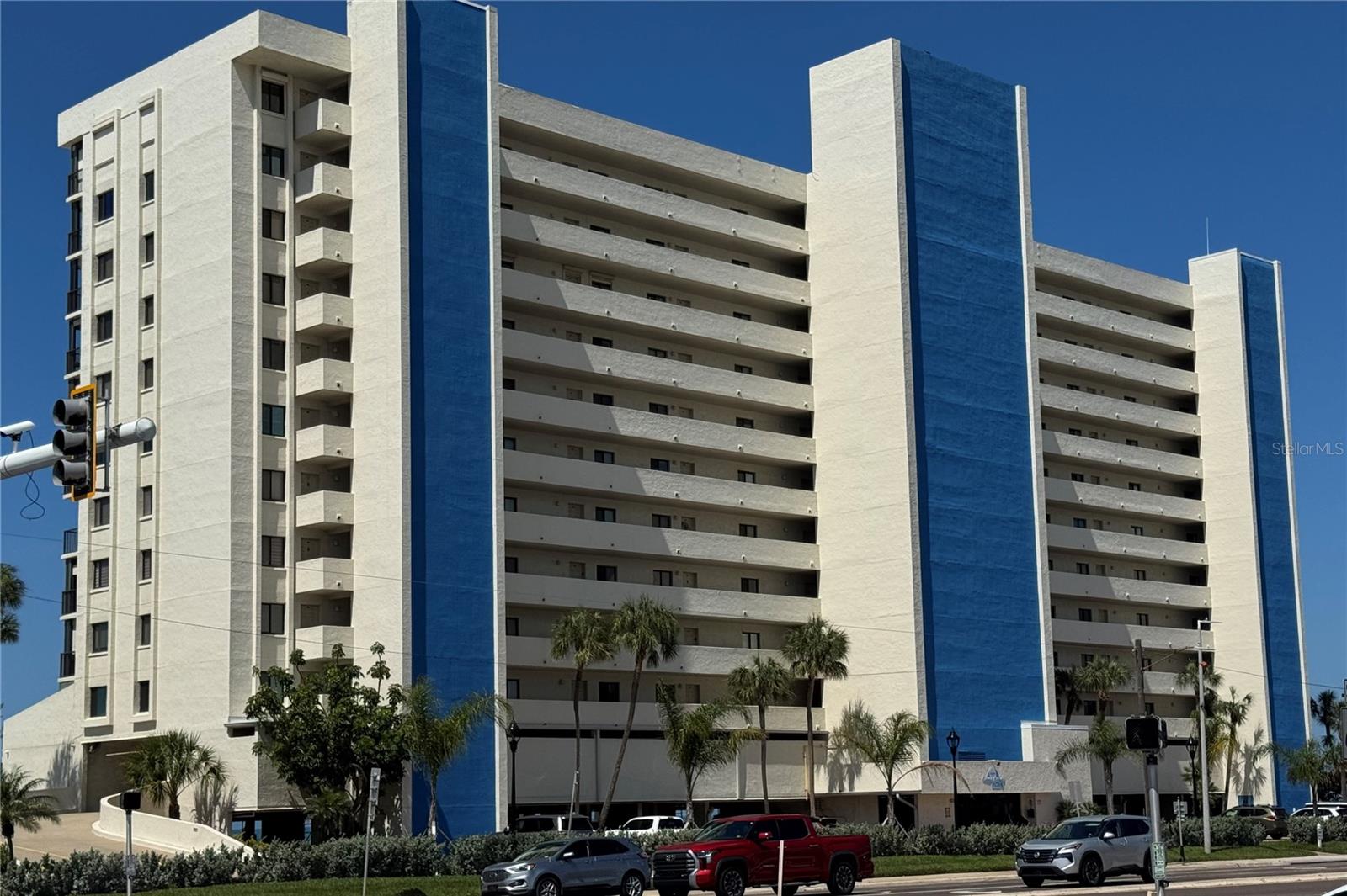 Welcome to Ocean Sands, a highly sought-after, impeccably managed, pet-friendly condominium community offering a luxurious resort-style lifestyle on the beautiful Gulf of America. This fully furnished CORNER UNIT features breathtaking panoramic Gulf views and is equipped with newer hurricane-impact windows and three-door panoramic sliders in the primary bedroom and living room. Whether relaxing inside or enjoying the expansive 30-foot balcony, you and your guests can take in the stunning scenery and refreshing coastal breezes.  Inside, the residence showcases a thoughtfully designed open floor plan with durable porcelain tile flooring throughout. Coastal charm is reflected throughout the home. The spacious kitchen features solid wood cabinetry, a breakfast bar, and a comfortable eat-in area.  Both bathrooms have been tastefully updated. The primary suite offers a private retreat with a generous walk-in closet, an oversized vanity, and a large walk-in shower.  Residents can enjoy a variety of resort-style amenities, including a spacious heated pool, relaxing hot tub, and a large sun deck. Outdoor features include a grill and tiki bar area, shuffleboard courts, and plenty of lounge chairs for soaking up the Florida sunshine.  This property is perfect as a beachside getaway, full-time residence, or an excellent short-term rental investment, with a flexible two-week minimum rental policy. Ocean Sands also provides covered parking, secure bicycle storage, and additional private storage for residents.  Located in the vibrant coastal community of Madeira Beach, you’ll be just minutes from the famous John’s Pass Village & Boardwalk, known for its waterfront dining, unique shops, fishing charters, and endless entertainment. MILESTONE INSPECTION COMPLETED!