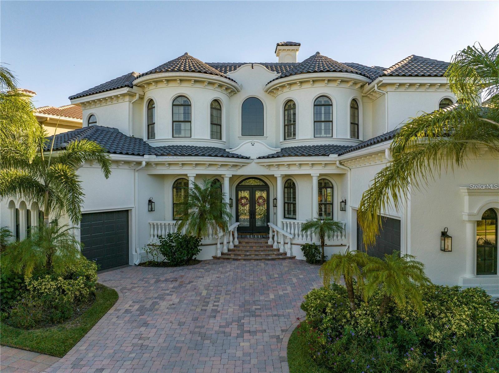 Welcome to one of Tampa Bay’s most coveted gated waterfront communities—The Reserve of Old Tampa Bay, known for its breathtaking sunrises and sunsets. This fully furnished custom residence delivers true resort-style living with a stunning Mugla white marble pool and spa, all remotely controlled via the Pentair app. The outdoor oasis is perfect for entertaining, featuring a built-in grill and smoker, granite bar seating, and a fire feature—ideal for al fresco dining. Inside, the home showcases a chef’s kitchen with Thermador and Sub-Zero appliances, a large walk-in pantry, butler’s pantry, and a laundry room conveniently located off the kitchen. The first floor offers brand-new flooring, soaring 12-foot ceilings, and a full-service elevator. Architectural details abound, including rich wood cabinetry, granite countertops, a sweeping staircase with wrought-iron railings, crown molding throughout, and oil-rubbed bronze fixtures. Each bedroom features its own en-suite bath, complemented by two separate office or bonus spaces for added flexibility. Ideally located just minutes from downtown Tampa, Tampa International Airport, and area beaches, this exceptional home offers luxury, privacy, and convenience in one of Florida’s premier communities.
