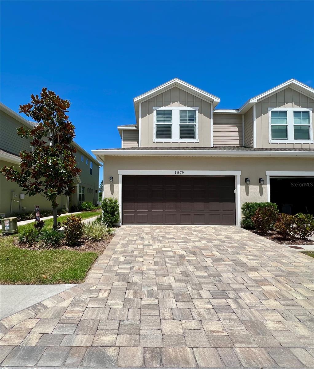 Welcome to this meticulously maintained luxury townhome in the brand new community Sutherland Trail, situated just moments from Downtown Palm Harbor, the Pinellas Trail, waterfront parks, public boat ramps, and golf cart friendly access. This home offers convenience and thoughtful upgrades that showcases pride of ownership.
With a brick paver driveway, oversized two car garage, and built on elevated FEMA-certified construction with no flood insurance needed. A unique feature includes sound attenuation insulation spray core foam in the common block wall for enhanced privacy.
Inside, elegant tile flooring flows throughout the home. The open-concept floor plan features crown molding throughout the first floor (excluding the powder bath), a spacious living area, and picturesque views of lush greenery through the rear sliding doors. The kitchen features quartz countertops, a custom handmade tile backsplash, upgraded cabinetry, an extended island enlarged by six inches to provide additional workspace and seating, as well as a custom dry bar. 
The first floor also offers a remote-controlled privacy shade on the rear sliding doors leading to the screened lanai with an upgraded birdcage enclosure install with 20/20 screening.
Upstairs, the primary bedroom features a tray ceiling accented with LED lighting, crown molding, and an oversized walk-in closet. The ensuite primary bathroom walk in shower has a custom tiled bench seat with river rock flooring.
Additional upgrades include a North Star 22,000-grain water softener system, a Big Blue whole-house reverse osmosis filtration system, and house color match accordion hurricane shutters installed on the rear primary bedroom windows for convenience. Every detail of this home reflects thoughtful planning.
Low HOA fees. Located right off of Alt 19 and near top rated schools. This is an opportunity to own a truly turn-key residence in one of Pinellas County's most desirable locations.