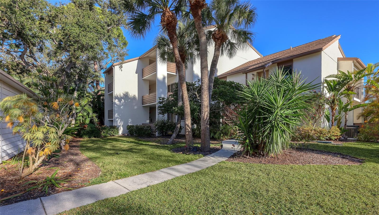 Accessible by elevator, this charming third-floor, one-bedroom, one-bath residence features vaulted ceilings and serene views of the pond and fountain. The welcoming kitchen is open to the spacious dining and living areas, providing plenty of room for relaxing and entertaining.  Step through the sliding glass doors to a large, screened lanai. Whether sipping coffee or hosting friends, the peaceful water view provides a calming backdrop. Retreat to the primary suite, which offers private access to the lanai and features a recently renovated en-suite bath complete with an oversized walk-in shower and a generous closet. A private laundry room is located off the lanai, and a dedicated storage space is included within the deeded carport. Meticulously maintained, the residence includes a new HVAC installed in 2024. Bird Bay Village offers a resort lifestyle just minutes from downtown Venice. Community amenities include a clubhouse, fitness center, pool, and courts for tennis, pickleball, shuffleboard and bocce ball. Residents enjoy an active social calendar with yoga classes, art shows and seasonal gatherings. The Legacy Trail, less than a quarter mile away, provides direct access to Venice Island for cycling, recreation and running. Venice Beach and Nokomis Beach are within three miles, offering convenient access to the Gulf’s pristine shoreline.