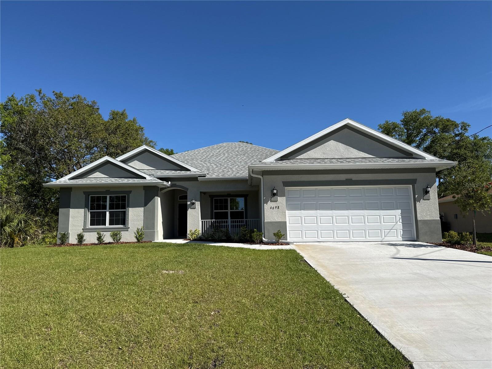 MAJOR PRICE REDUCTION !! NEW CONSTRUCTION! MOVE IN READY! This 3 bedroom home has spacious rooms with an open/split floor plan. 9'4" Ceilings. The kitchen has a granite countertop. Breakfast bar compliments the kitchen. Great room is in combination with the kitchen as an open concept. There are 2 sets of French doors from the great room which leads to the covered porch. The split bedroom plan has a spacious primary bedroom which features a Tray ceiling, walk in closet, separate walk in shower and double sinks. The home has a separate laundry room with cabinet space and utility sink situated between the kitchen and 2 car garage. GE appliances which includes a Microwave, Range and Dishwasher.
