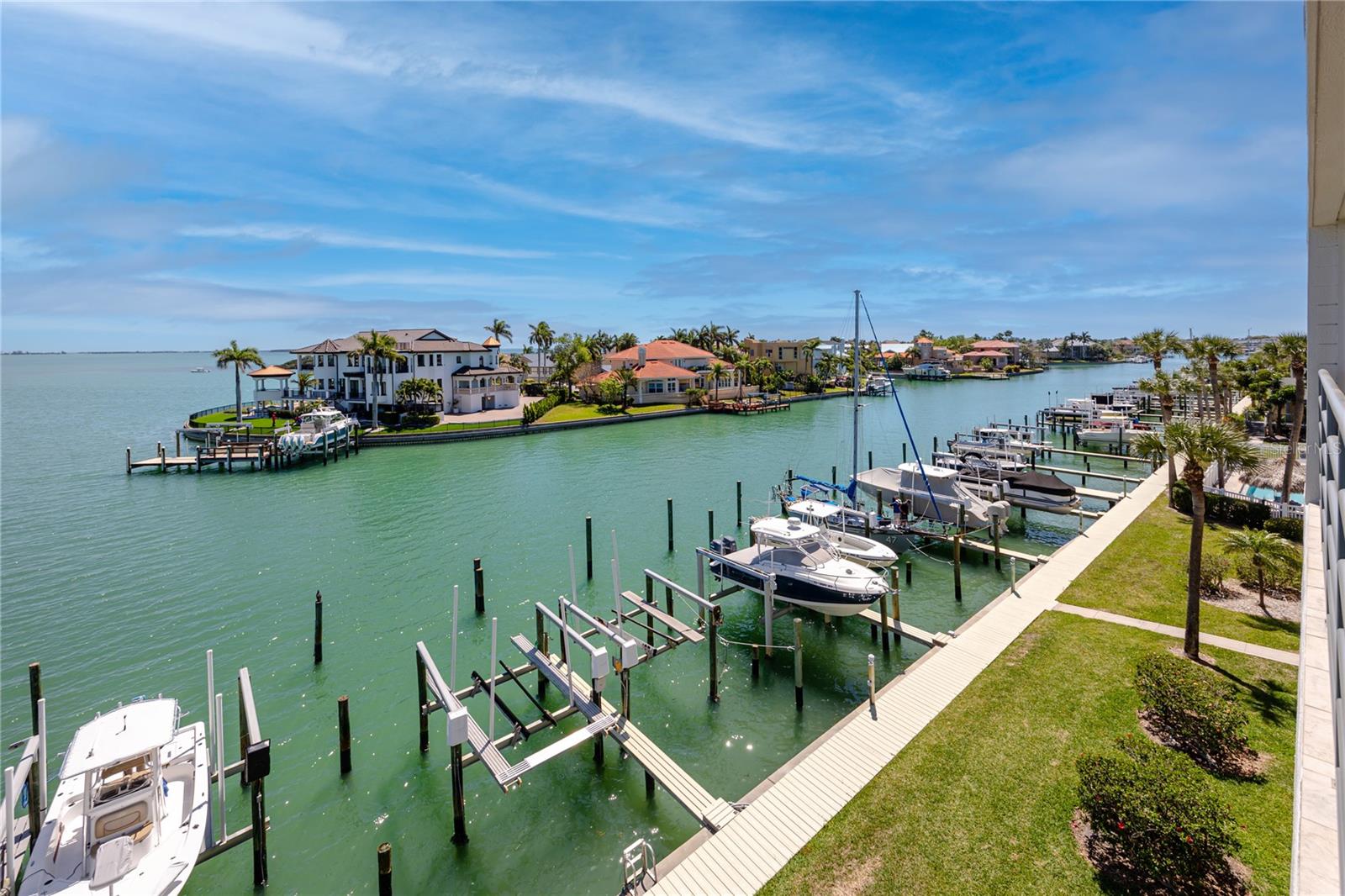 Experience refined waterfront living in this top-floor residence in desirable Tierra Verde’s Anchor Cove.This spacious residence showcases sweeping water views from the kitchen, great room, and primary suite, all opening to an expansive 9’ x 26’ balcony, the perfect place to relax and enjoy passing dolphins and coastal wildlife, complete with dual ceiling fans, a large storage closet, and electric hurricane shutters.Elevated ceilings and an open-concept design create a bright, airy atmosphere throughout the home.

The beautifully updated kitchen is thoughtfully designed with stone countertops, abundant wood cabinetry, premium KitchenAid appliances including a commercial-style steam/convection microwave and Superba convection oven, a pantry with pull-out shelving, breakfast bar seating, and a built-in workspace, ideal for both everyday living and entertaining.

The waterside primary suite offers stunning Tampa Bay views to start your day, while the en-suite bath features dual vanities, a spacious frameless glass shower, and two closets, including a walk-in.

Boating enthusiasts will appreciate the convenient access to the Intracoastal Waterway, Pass-a-Grille Channel, and the Gulf, with improved navigation via the Tierra Verde bridge. Wet slip included.
Anchor Cove is a well-built, amenity-rich community offering a large waterfront pool and spa, two tennis courts, elevator access, covered tandem parking for two vehicles with additional storage, ample guest parking, and a pet-friendly policy. Ideally located on the island, you’re just minutes from Fort De Soto Park, St. Pete Beach, Pass-a-Grille, I-275, and vibrant downtown St. Petersburg, as well as nearby airports.

Enjoy the best of coastal luxury living with resort-style amenities, boating access, and beautiful open water views in one of Tierra Verde’s most sought-after communities.