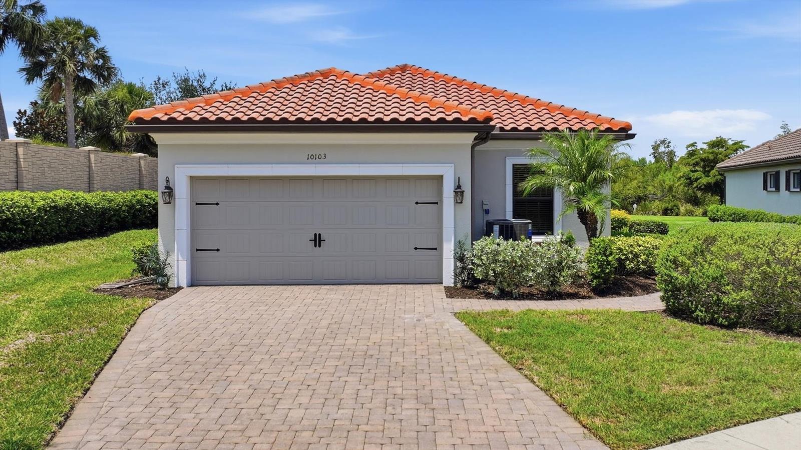 Set on an oversized cul-de-sac lot in the gated resort-style community of Esplanade at Artisan Lakes, this 3-bedroom, 2-bath home with a dedicated den features a NEW A/C with UV (2024), spacious layout, large screened lanai, and a backyard setting with room to enjoy Florida living. The entry opens into the main living area, where a tray ceiling, recessed lighting, and large sliding doors create a bright, open space that connects directly to the lanai. The kitchen features granite countertops, stainless steel appliances, dark wood cabinetry, a pantry, and a large breakfast bar with seating. Just beyond, the dining room offers a defined space for meals, gatherings, and entertaining. A dedicated den provides flexible space for a home office, reading room, hobby area, or additional lounge space. The primary bedroom is positioned privately with plantation shutters, a walk-in closet, and an en suite bathroom featuring dual vanities, a soaking tub, walk-in shower, and private water closet. Two secondary bedrooms and a full bathroom are located on the opposite side of the home, creating comfortable separation for guests or household members. The screened lanai extends the living space outdoors with a covered sitting area and peaceful views of the surrounding greenery. The oversized homesite offers more than a quarter acre with room to relax, garden, entertain, or explore future outdoor possibilities. Additional features include a laundry room, two-car garage, and NEW garage door spring system replaced in 2023. Esplanade at Artisan Lakes offers an impressive amenity-rich lifestyle with a resort-style pool, spa, fitness center, clubhouse, café, billiards and game room, tennis, pickleball, bocce, walking trails, event lawn, dog park, and a full calendar of activities. Association dues include cable, internet, and grounds maintenance, adding convenience to the resort-style setting. Located near I-75, residents enjoy convenient access to Sarasota, St. Petersburg, vibrant dining, shopping, entertainment, and the renowned Gulf Coast beaches.