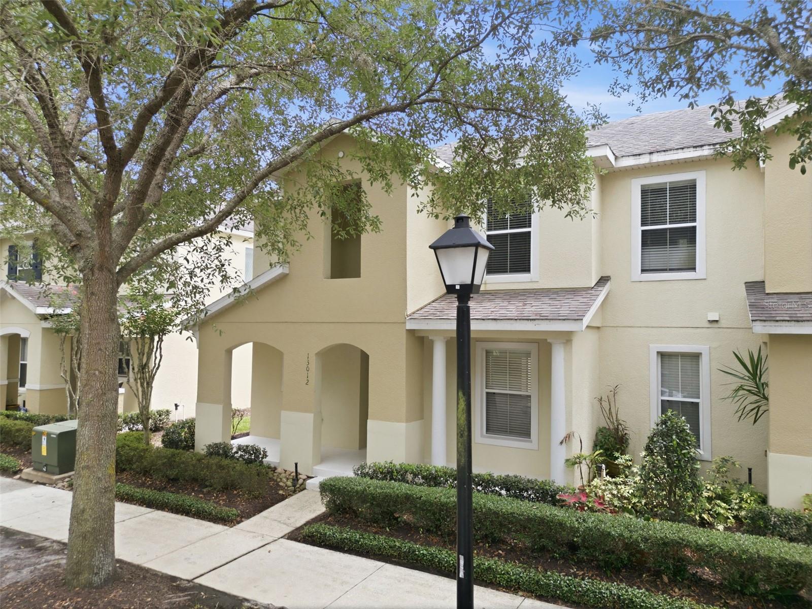 Virtually Staged. Welcome Home to the Heart of Avalon Park, where Community is a Lifestyle!Rarely available and truly move-in ready, this stunning end unit townhome on a quiet, tree lined street in the heart of Avalon Park is the one you've been waiting for. With 3 bedrooms, 3 full bathrooms, a 2-car attached garage, and a versatile office/den/playroom on the first floor (with a full bath right nearby...hello, 4th bedroom option!), this pristine home has the space and flexibility your family needs.Step inside and feel the difference an end unit makes wit extra natural light, extra privacy, and a bright, open-concept layout that flows beautifully from the kitchen through the dining area and into the family room. The kitchen offers rich wood cabinetry with extra added storage, granite countertops, a stone backsplash, and an easy flow to the private outdoor patio through sliding glass doors that is perfect for morning coffee or evening gatherings.The entire home features gorgeous wood-look laminate flooring and tile throughout, making cleanup easy and the look timeless. You'll also find generous storage throughout the home, a true luxury in townhome living.Upstairs, your spacious primary bedroom retreat awaits with a large walk-in closet and an en suite bath featuring double sinks and granite counters. Even the guest bathroom is a step above, with double sinks for stress-free mornings. The laundry room is conveniently located upstairs and yes, the washer and dryer stay! Recent updates bring peace of mind: A/C replaced in 2023 and water heater in 2022.Now for the lifestyle that makes Avalon Park truly special. Step outside and you're steps from it all. More than 16 miles of scenic trails wind through the community, connecting residents to Downtown Avalon Park, village parks, and schools. Downtown Avalon Park is home to community festivals, Movies Under the Stars, a beloved dog park, and a vibrant one-acre central park. Baseball, soccer, and football fields, basketball and tennis courts, and miles of walking and biking paths blend fitness and fun as you wind past scenic preservation areas, grassy fields, and peaceful ponds. Publix is an easy walk away for your weekly grocery run, and Downtown Avalon Park's shops, restaurants, and professional services mean you truly never have to go far. Waterford Lakes Town Center is just minutes away for bigger retail needs and dining. This is more than a home. It's a community. It's a lifestyle!