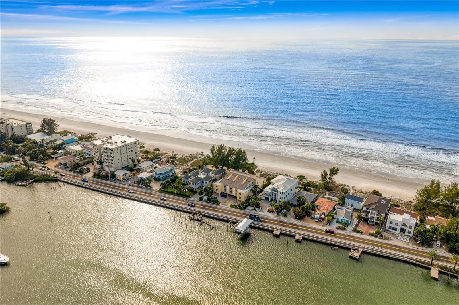 Rare opportunity to own a true income-producing beach getaway in the heart of Indian Shores! This beautifully positioned condo offers the best of both worlds with direct Gulf views from the back and Intracoastal Waterway views from the front, delivering stunning sunrises and sunsets right from your home.  Located on the sugar-white sands of Gulf of Mexico, this property is weekly rental friendly, making it an ideal investment, vacation home, or full-time coastal retreat. Short-term rental flexibility allows for strong income potential in one of Pinellas County’s most desirable beach communities.  Inside, you’ll find a bright and airy layout designed to maximize natural light and water views. Whether you're relaxing after a day at the beach or hosting guests, the open living space provides a seamless indoor-outdoor feel.  Covered parking, extra storage unit, wood burning fireplace, and a brand-new elevated AC unit with ductwork, all make this home a must see!!  Furniture negotiable