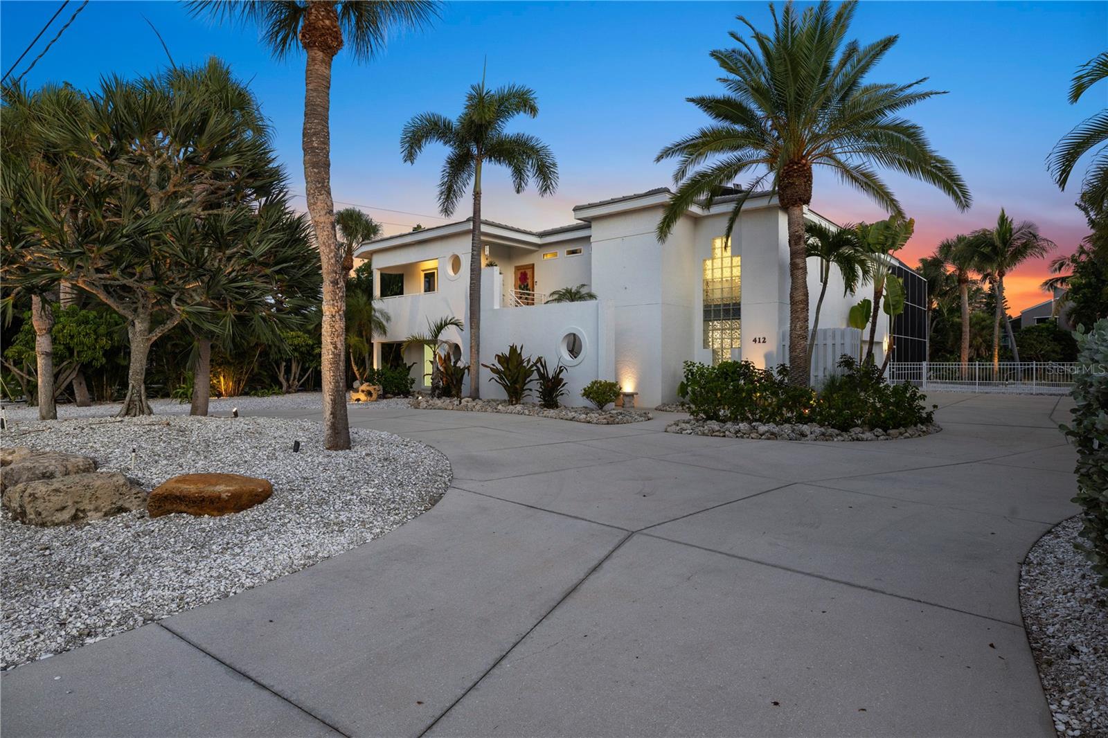 Luxury Waterfront Pool Home with Private Dock on Siesta Key

Welcome to 412 Treasure Boat Way, an exceptional luxury waterfront residence that captures the very essence of Siesta Key living. Perfectly positioned along one of the island's desirable boating canals, this private waterfront home offers a seamless blend of timeless coastal architecture, sophisticated design, and the relaxed elegance that defines Florida's Gulf Coast lifestyle.

Offering approximately 2,341± square feet, this beautifully designed 4-bedroom, 4-bathroom residence is thoughtfully crafted to maximize natural light, indoor-outdoor living, and tranquil water views. Expansive gathering spaces flow effortlessly to the resort-style outdoor living areas, creating an inviting atmosphere for entertaining, relaxing, and enjoying the beauty of the waterfront.

The heart of the home is a well-appointed kitchen that opens to spacious living and dining areas, while large windows and sliding glass doors embrace the surrounding tropical landscape and peaceful canal setting. Every room has been designed to celebrate the home's exceptional waterfront location while providing comfort, privacy, and effortless everyday living.

Step outside to your own private coastal retreat featuring a screen-enclosed resort-style pool, expansive lanai, lush tropical landscaping, and a private dock with convenient boating access to Sarasota Bay and the Gulf of Mexico. Spend your mornings kayaking or paddleboarding, enjoy afternoons on the water, and end each evening poolside as spectacular Florida sunsets reflect across the canal.

Located just minutes from the world-renowned white quartz sands of Siesta Key Beach, Siesta Village's award-winning restaurants, boutiques, marinas, and entertainment, as well as the acclaimed arts, shopping, dining, and cultural attractions of downtown Sarasota, this residence offers an exceptional combination of luxury, privacy, convenience, and the coveted waterfront lifestyle.

Whether you are searching for a Siesta Key waterfront home, luxury waterfront real estate in Sarasota, a private dock home, Florida Gulf Coast boating property, or an elegant seasonal retreat, 412 Treasure Boat Way presents an exceptional opportunity to own in one of the nation's most desirable coastal communities.

More than a residence, this is a lifestyle defined by boating, sunshine, waterfront living, and unforgettable sunsets. Welcome home.

Property Highlights

• Luxury waterfront residence on Siesta Key
• Approximately 2,341± square feet
• 4 Bedrooms | 4 Bathrooms
• Private dock with boating access to Sarasota Bay and the Gulf of Mexico*
• Screen-enclosed resort-style pool
• Open-concept living and entertaining spaces
• Tropical landscaping
• Minutes to Siesta Key Beach, Siesta Village, and downtown Sarasota
• Ideal for boating, fishing, paddleboarding, kayaking, and year-round coastal living

Buyer should independently verify all measurements, water access, boating capabilities, dock specifications, and any restrictions to their satisfaction.