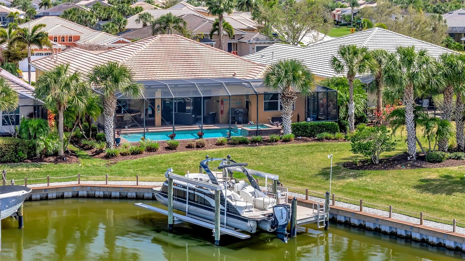 Luxury Waterfront Living in Tidewater Preserve—This gorgeous home offers 4 Bedrooms, 4.5 Bathrooms, Pool & Spa plus Private Dock w/ 14,000 LB boat Lift and a 3-car garage.  Discover the perfect balance of elegance, comfort, and true Florida waterfront living in this exceptional residence located in the highly sought-after, guard-gated community of Tidewater Preserve. Thoughtfully designed with an open floor plan and elevated finishes throughout, this home offers a seamless blend of refined interior spaces and resort-style outdoor amenities. This is a Boater’s Paradise with Direct Water Access. Positioned on premium waterfront, the property features a private dock with a 14,000-pound boat lift with unobstructed access, making it effortless to launch your boat and explore the Manatee River, Tampa Bay, Anna Maria, and Gulf of America. Whether you’re heading out for a morning cruise or a sunset adventure, this home places the best of coastal living right at your doorstep. Resort-Style Outdoor Living & Entertaining: The expansive outdoor living area is the true centerpiece of the home — a private retreat designed for unforgettable gatherings and everyday relaxation. Enjoy A large outdoor bar with seating for multiple guests, two refrigerators for effortless entertaining, A built-in grill and Kamado Joe smoker for gourmet outdoor cooking, two retractable awnings offering shade and comfort on demand. An outdoor TV perfect for game days and movie nights, A sparkling pool and spa overlooking the water, and A convenient pool bathroom with shower. This is outdoor living at its finest — a space that feels like your own personal resort.  Elegant Interior with High-End Finishes. Inside, the home continues to impress with a bright, open layout that flows naturally toward the outdoor living area. The kitchen features custom cabinetry and quartz countertops, offering both beauty and functionality. The master bedroom offers privacy it's own expansive ensuite bath complete with garden tub and large walk in shower. One guest bedroom includes its own ensuite bathroom while the other two share a bathroom, providing privacy and comfort for family and guests. Additional highlights include a new washer and dryer and thoughtfully selected finishes throughout. Central vacuum, Rare 3-Car Garage Configuration: A highly desirable feature, the home offers a 2-car garage plus a separate 3rd-car garage, ideal for additional vehicles, storage, recreational equipment, or a dedicated workshop.  Tidewater Preserve is a Premier Waterfront Community--Residents of Tidewater Preserve enjoy an unmatched array of amenities, including: Private on-site marina, Tennis courts, Gym, Three community pools, Two clubhouses, Playground & dog park, Walking trails, Kayak launch ,Community boat lift, Direct access to the Manatee River and Gulf of America and resident activities that are offered throughout the year. All within a guard-gated community offering peace of mind and a vibrant, active lifestyle. Conveniently located near grocery stores, restaurants, shopping, and some of Florida’s most beautiful beaches, this home offers the perfect combination of luxury, convenience, and coastal living.